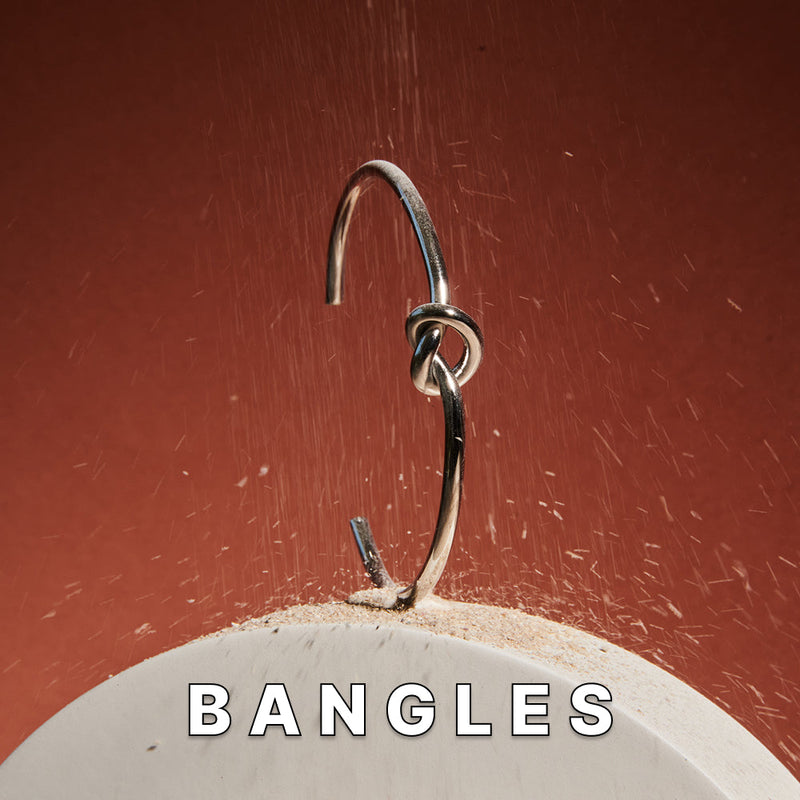 Close-up of Maresi metal bracelet bangle with knot detail