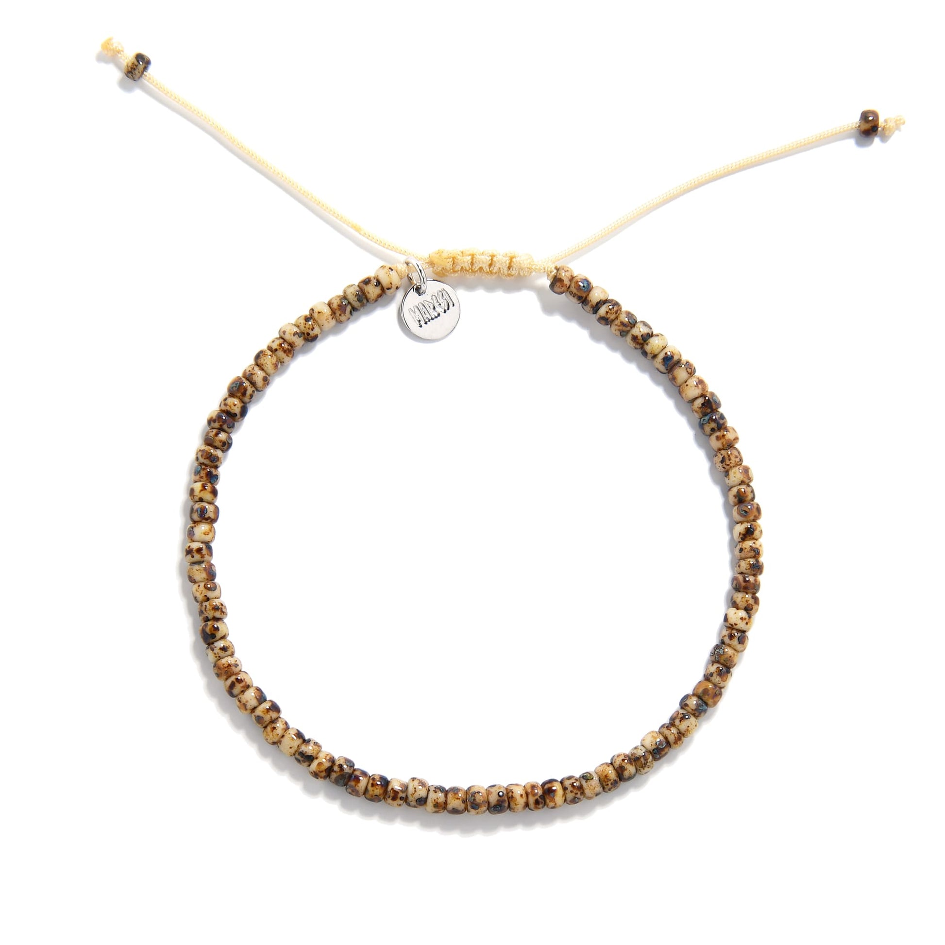 Flat lay of bead bracelet for men featuring earthy speckled beads and tan adjustable cord