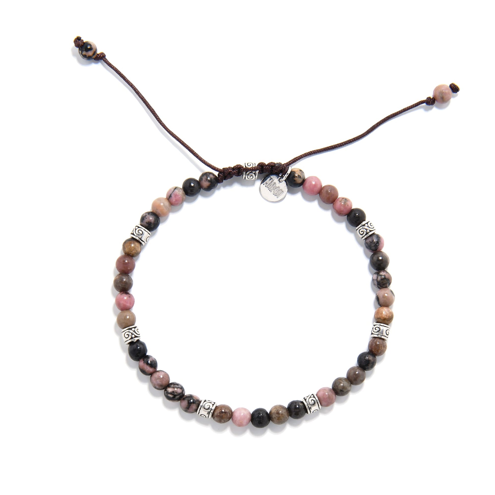 Top view of a round rhodonite bead bracelet showing the balanced arrangement of pink, brown, and black tones with detailed silver spacers.