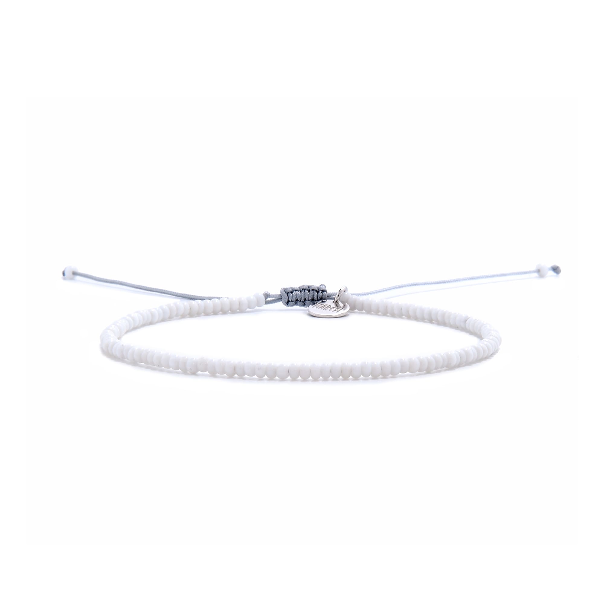 Adjustable small beaded bracelets in white with silver charm