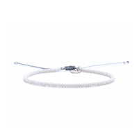 Adjustable small beaded bracelets in white with silver charm