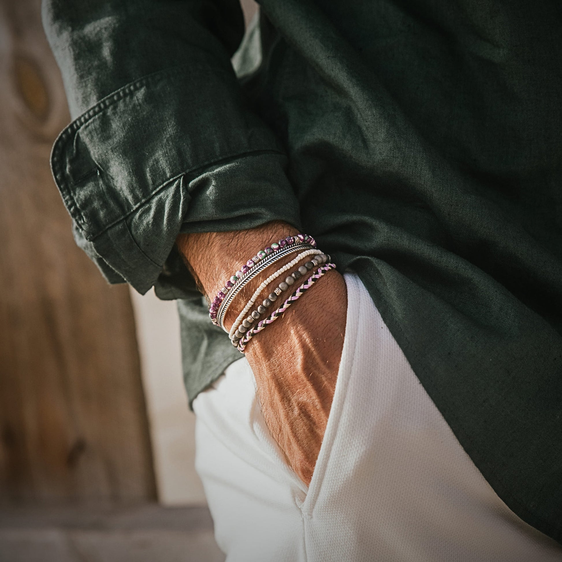 Man wearing Amalfi bracelet set with purple and silver tones