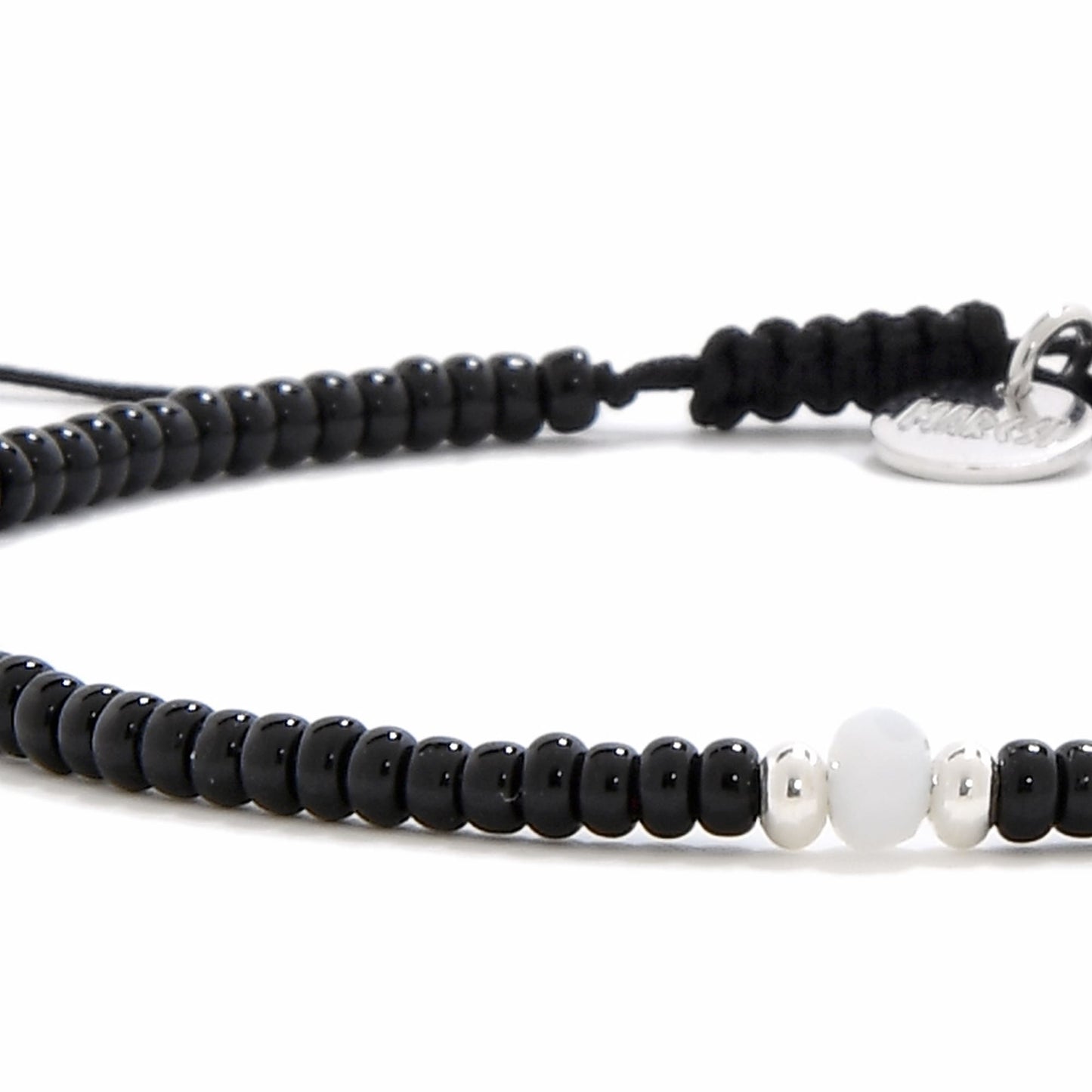 Close-up of Loreto Blanco Diamanti bead bracelet black with polished black and silver-white beads