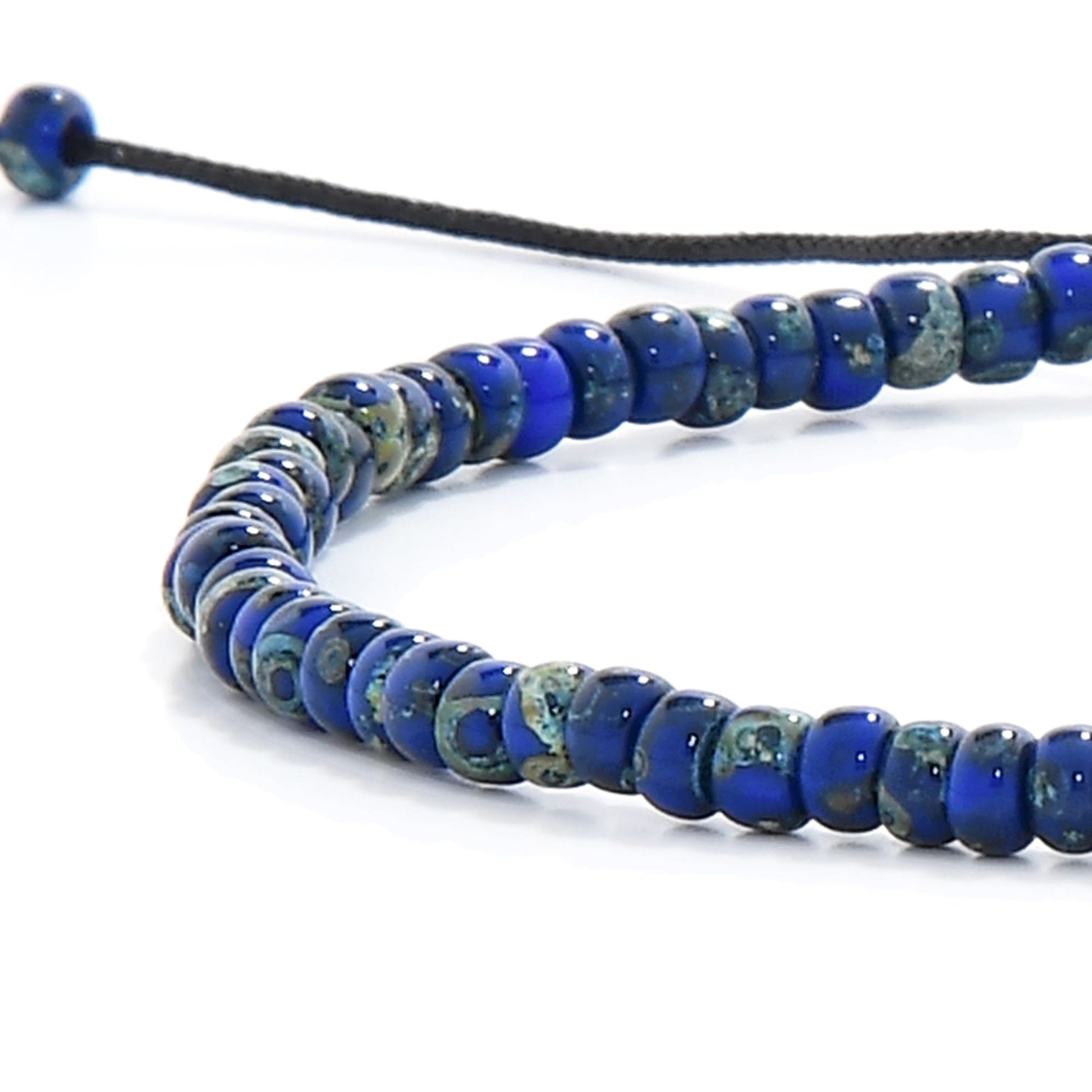 Close-up of beaded bracelet for men with mixed blue seed beads and black cord