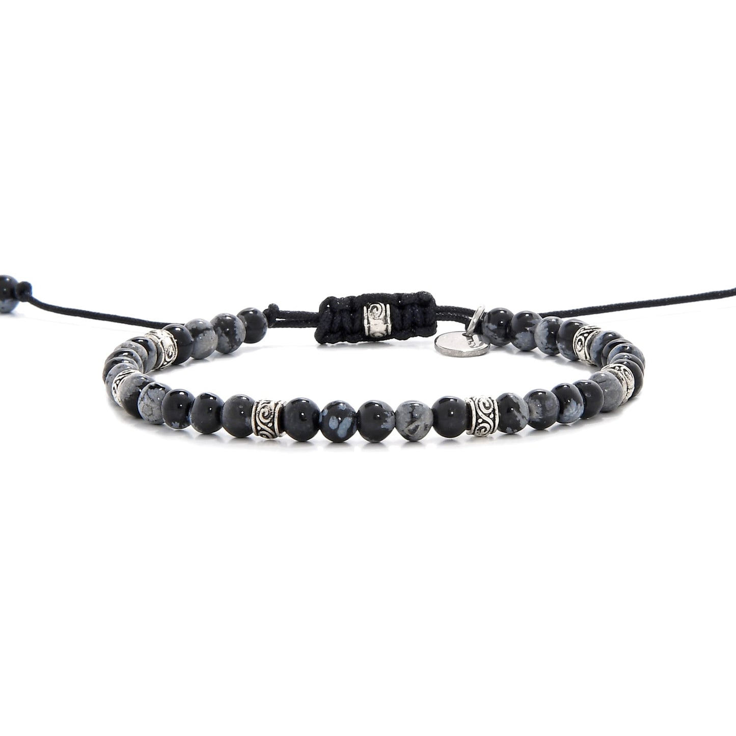 Full side view of the black stone bracelet laid out flat with black cord and adjustable clasp.