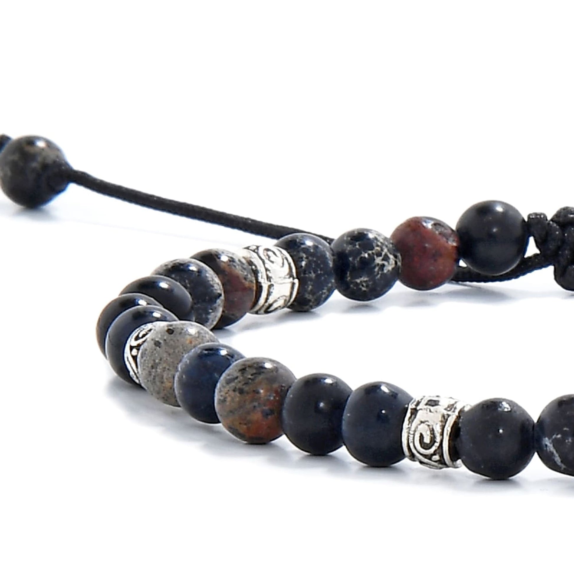 Black jasper beads close-up showing natural stone texture and silver spacer accents.