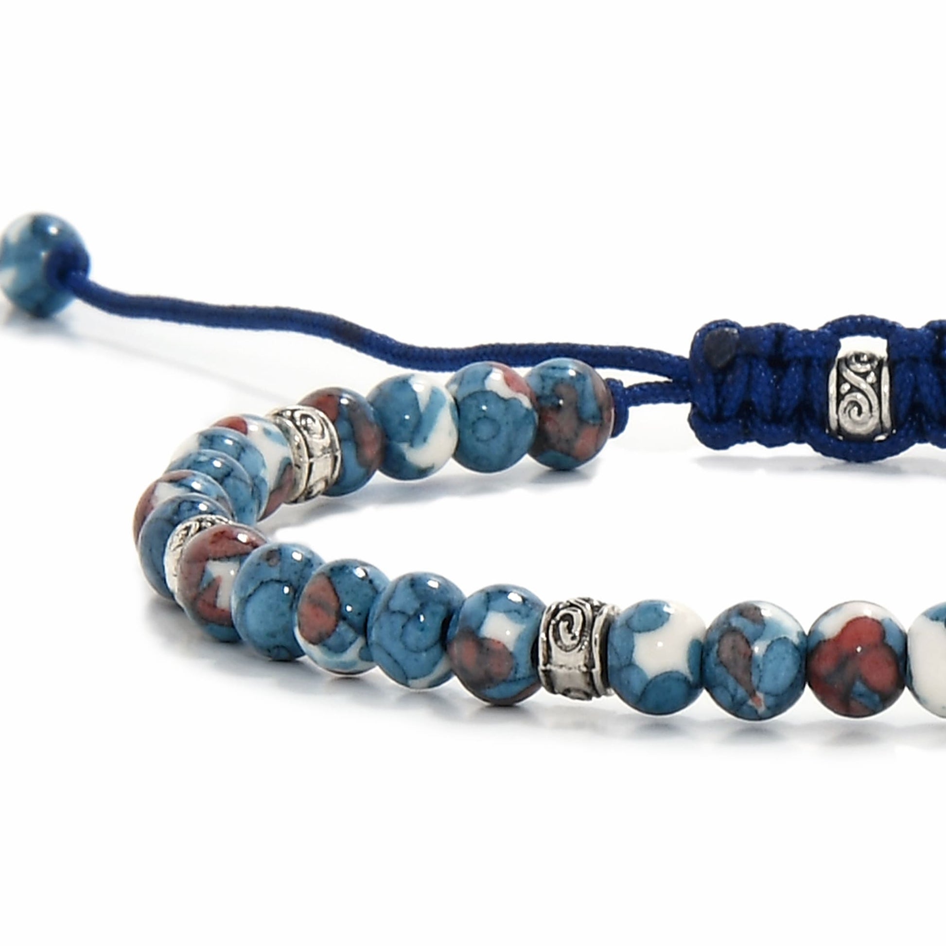 Macro shot of blue flower jasper bracelet featuring colorful marbled beads and intricate silver spacers.