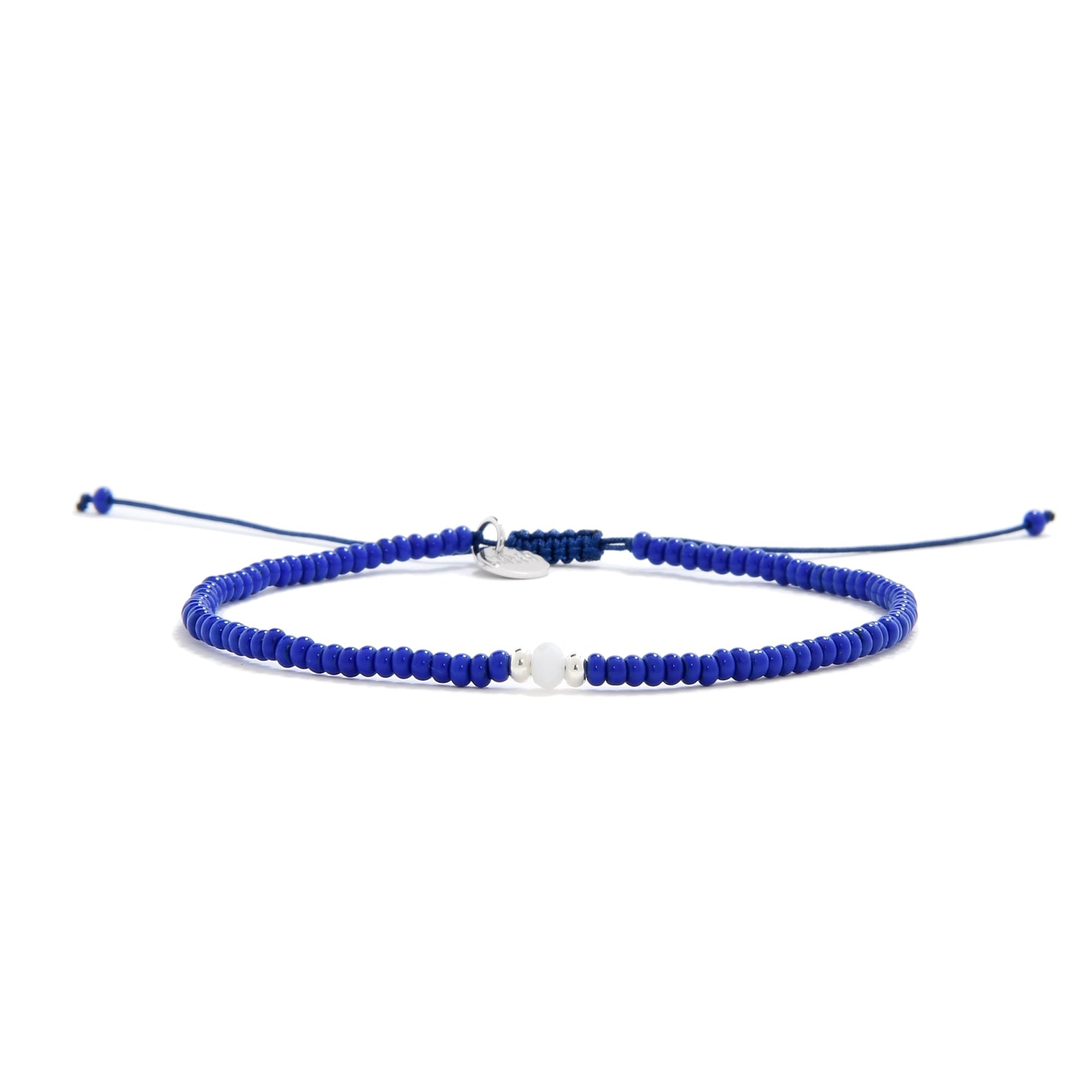 Blue seed bead bracelet idea with white bead centerpiece and navy adjustable cord