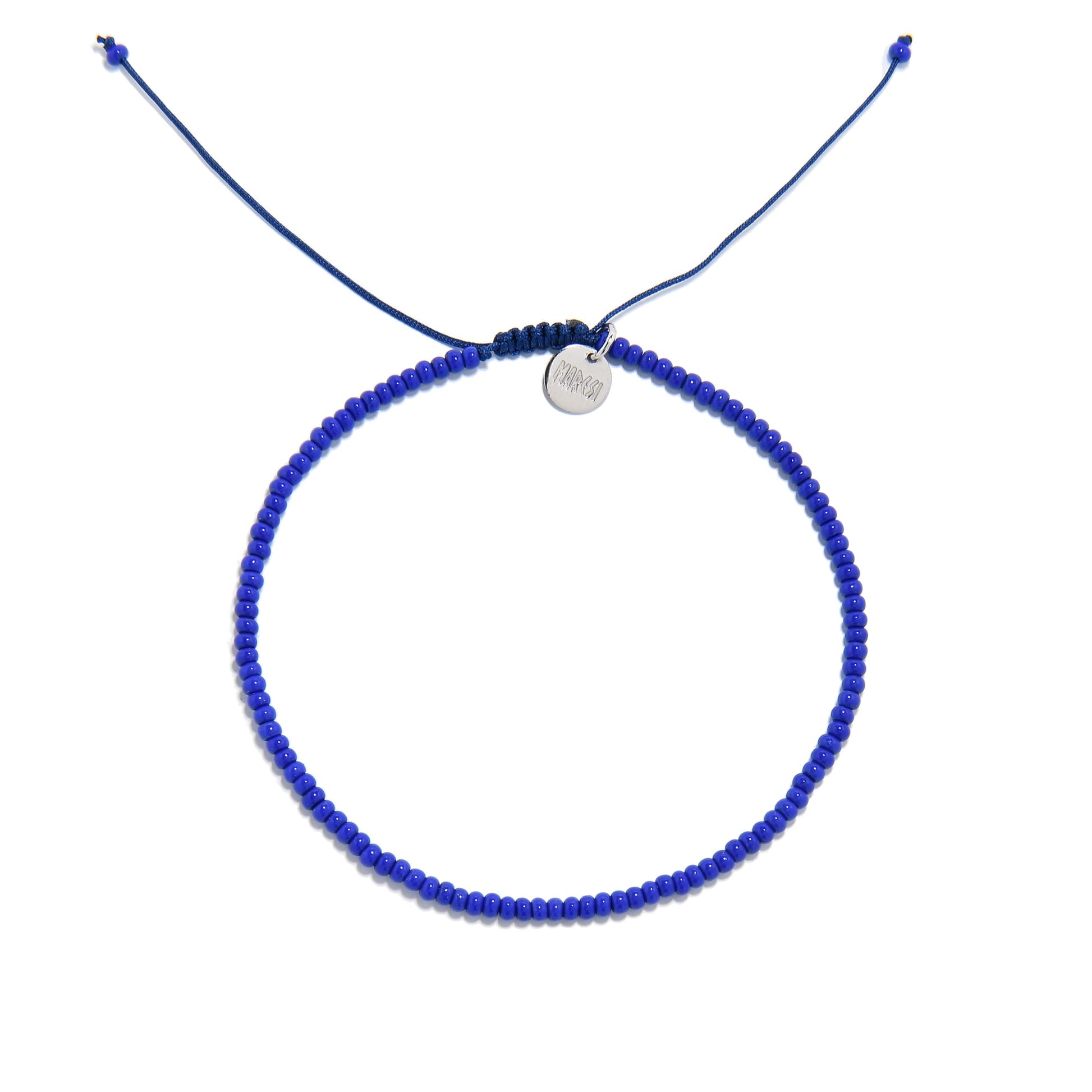 A top-down photo of a cobalt blue bracelet, an example of our stretch bead bracelets, arranged in a circle on a white background.