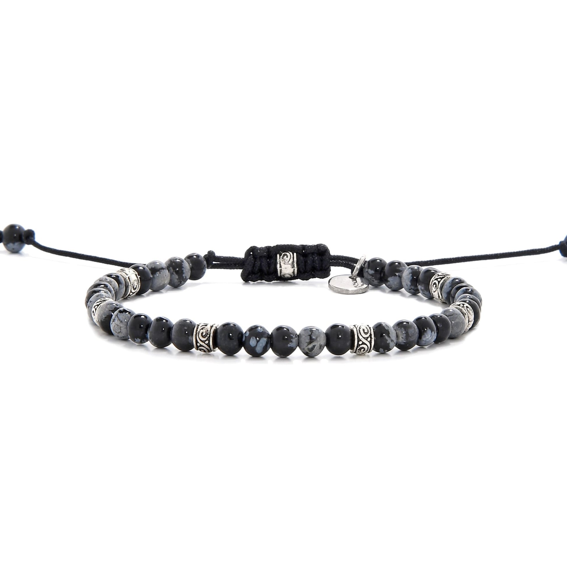 Full side view of the Bracelet Black Stone laid out flat with black cord and adjustable clasp.