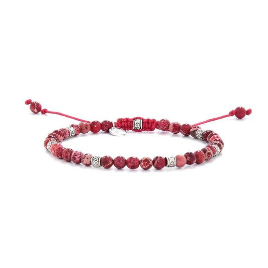 Bracelet red jasper beads with silver spacers on adjustable red cord.