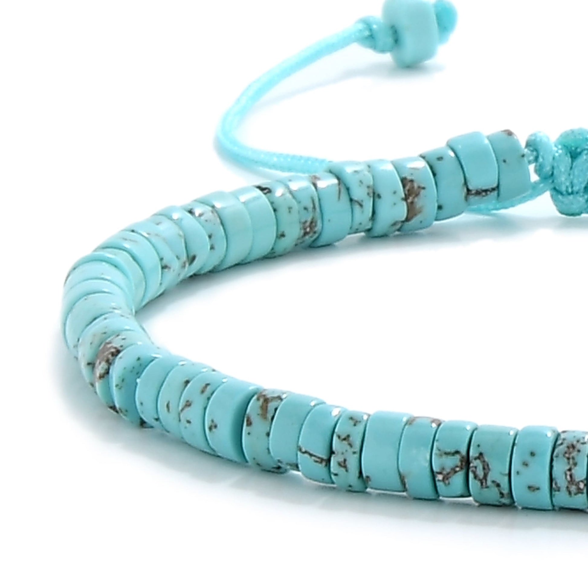Close-up view of clay bracelet with natural turquoise beads and blue cord