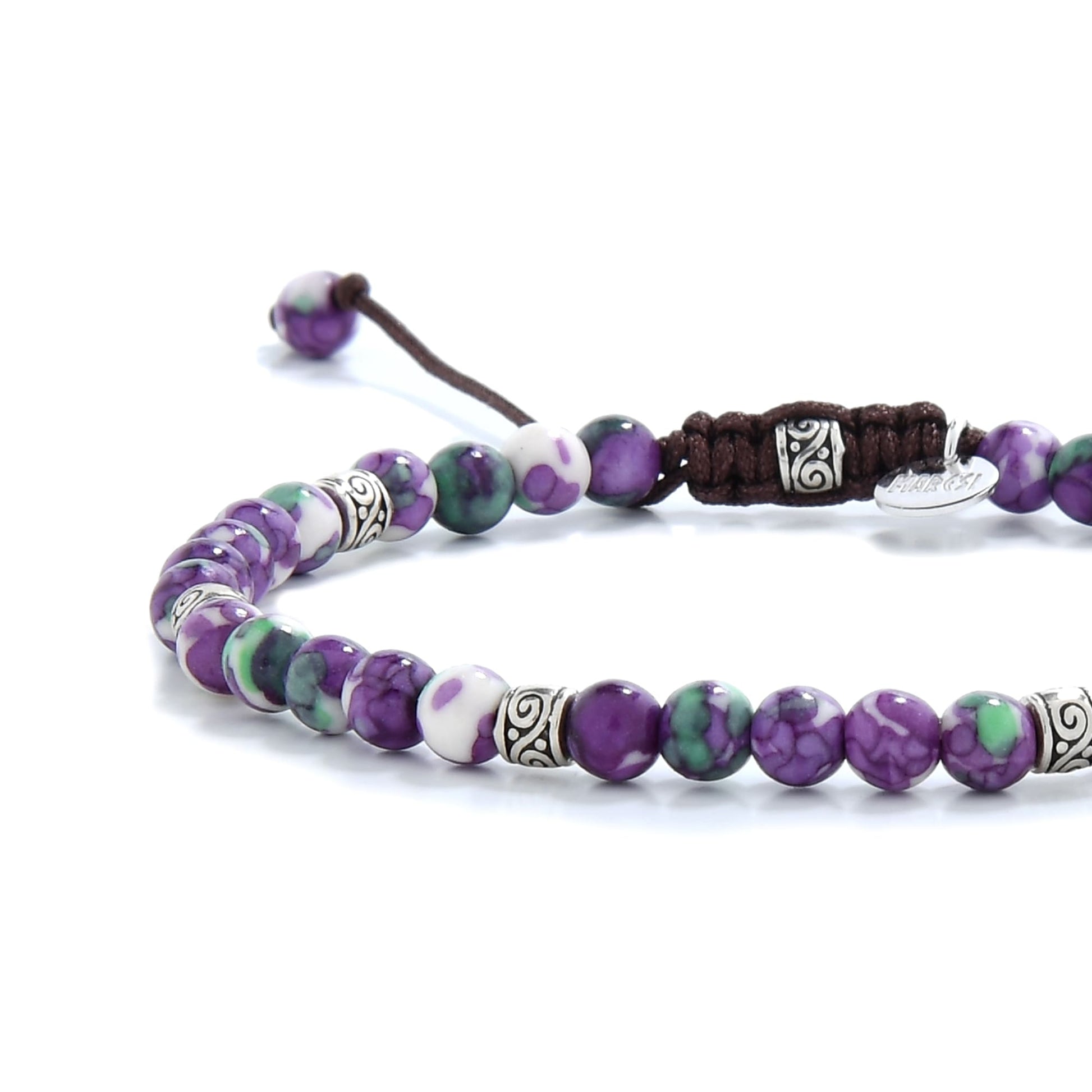 Polished jasper flower beads in purple and green with silver spacers.
