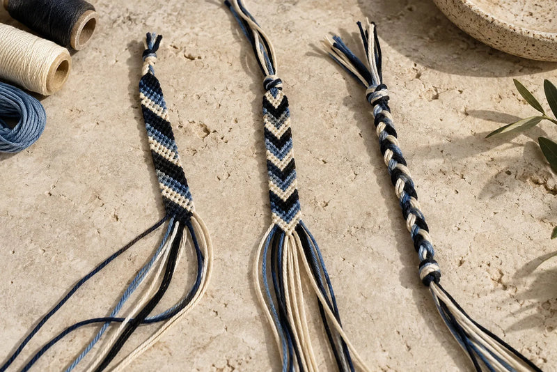 Three friendship bracelets in progress showing striped, chevron, and braided patterns with loose threads.