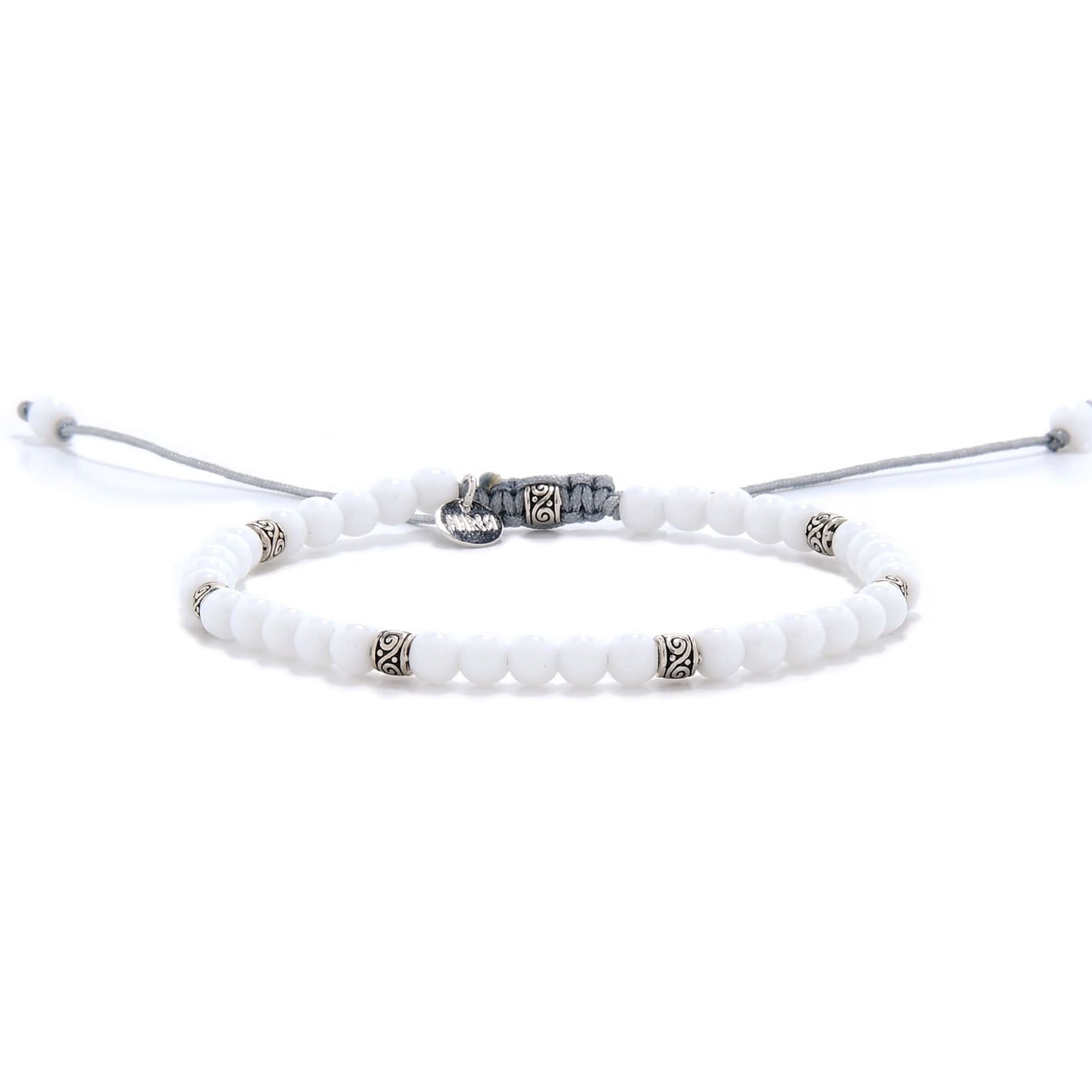 Elegant white jade bracelet with silver accents and adjustable cord.