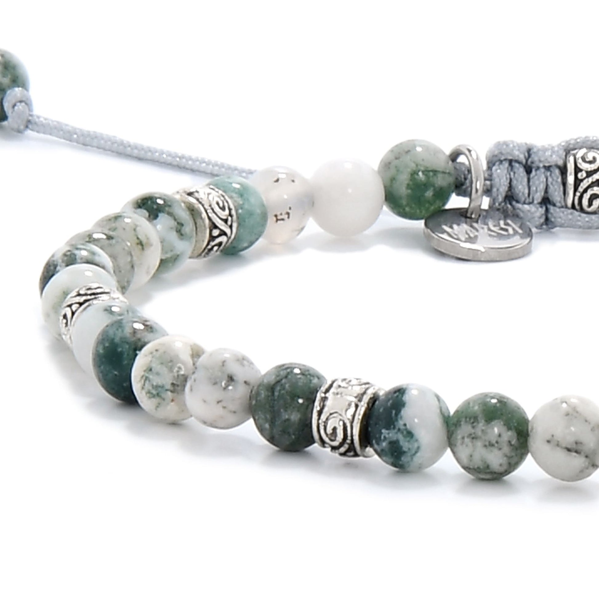 Detailed section of moss agate bracelet with unique patterns and polished texture, highlighting the bracelet’s natural look and metal spacers.