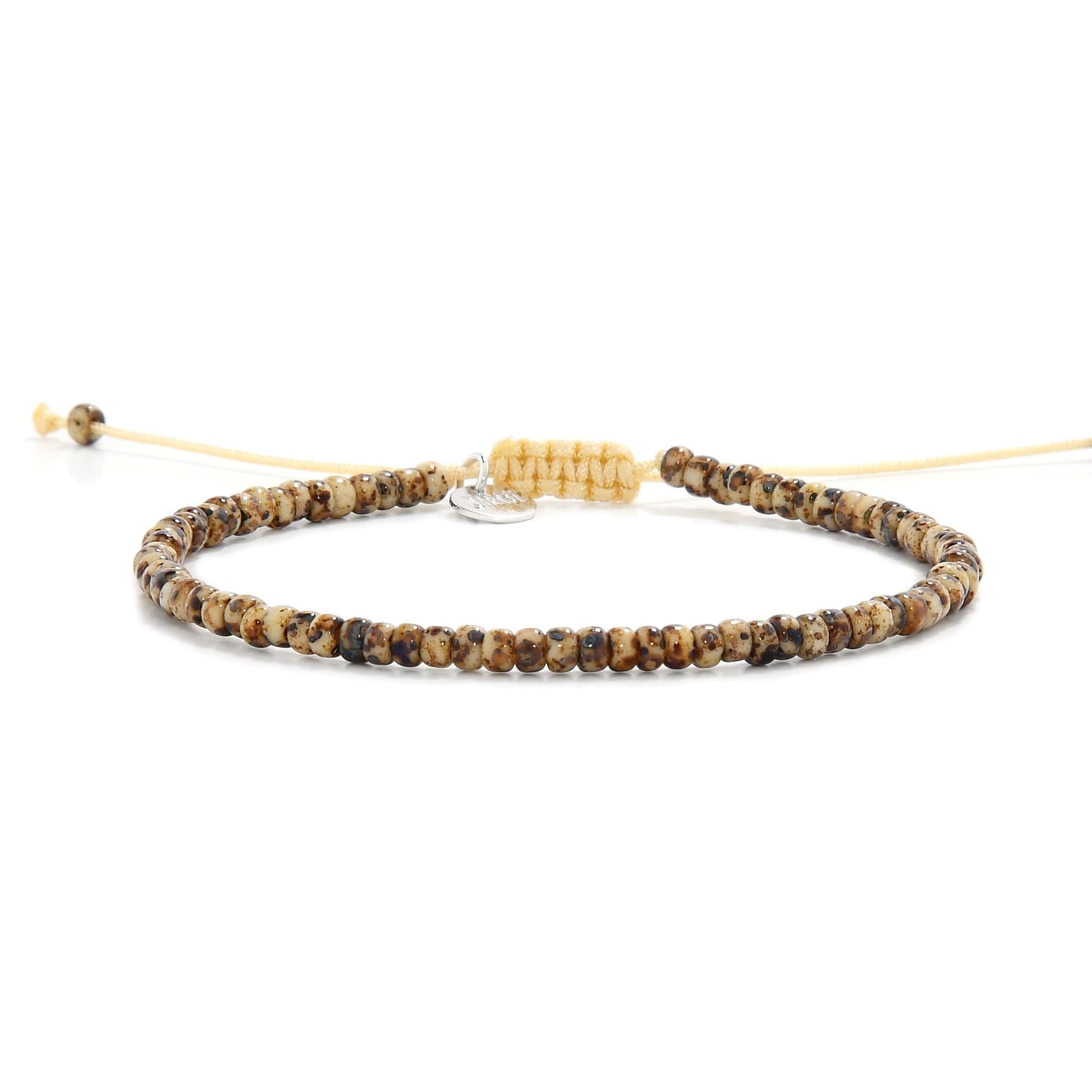 Flat lay of bead bracelet for men with Picasso-finish Czech beads and cream cord