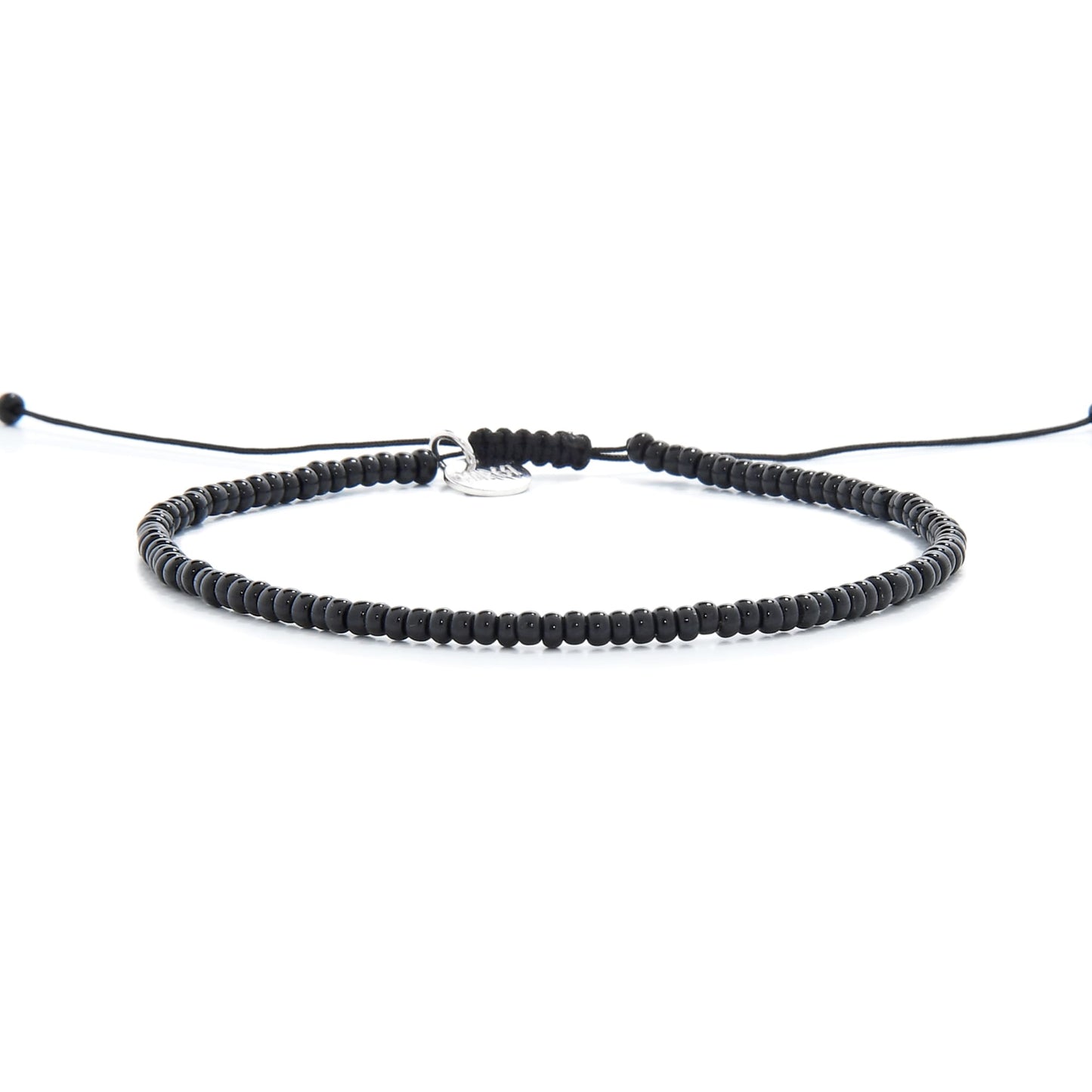 Frontal image of black bead bracelet laid out for display