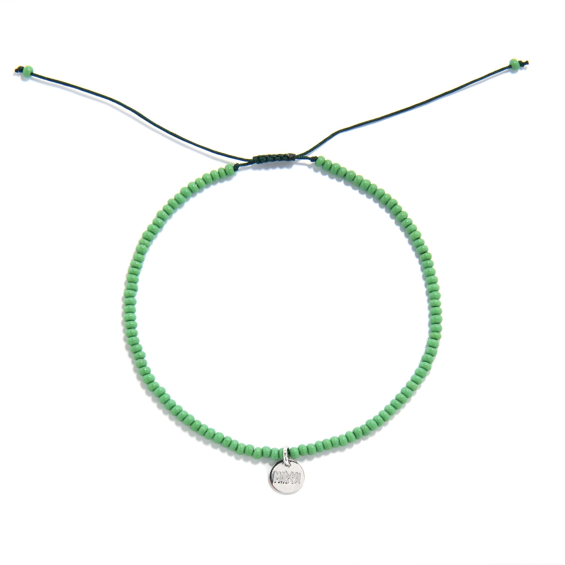 Overhead view of green beaded stretch bracelet in circular shape