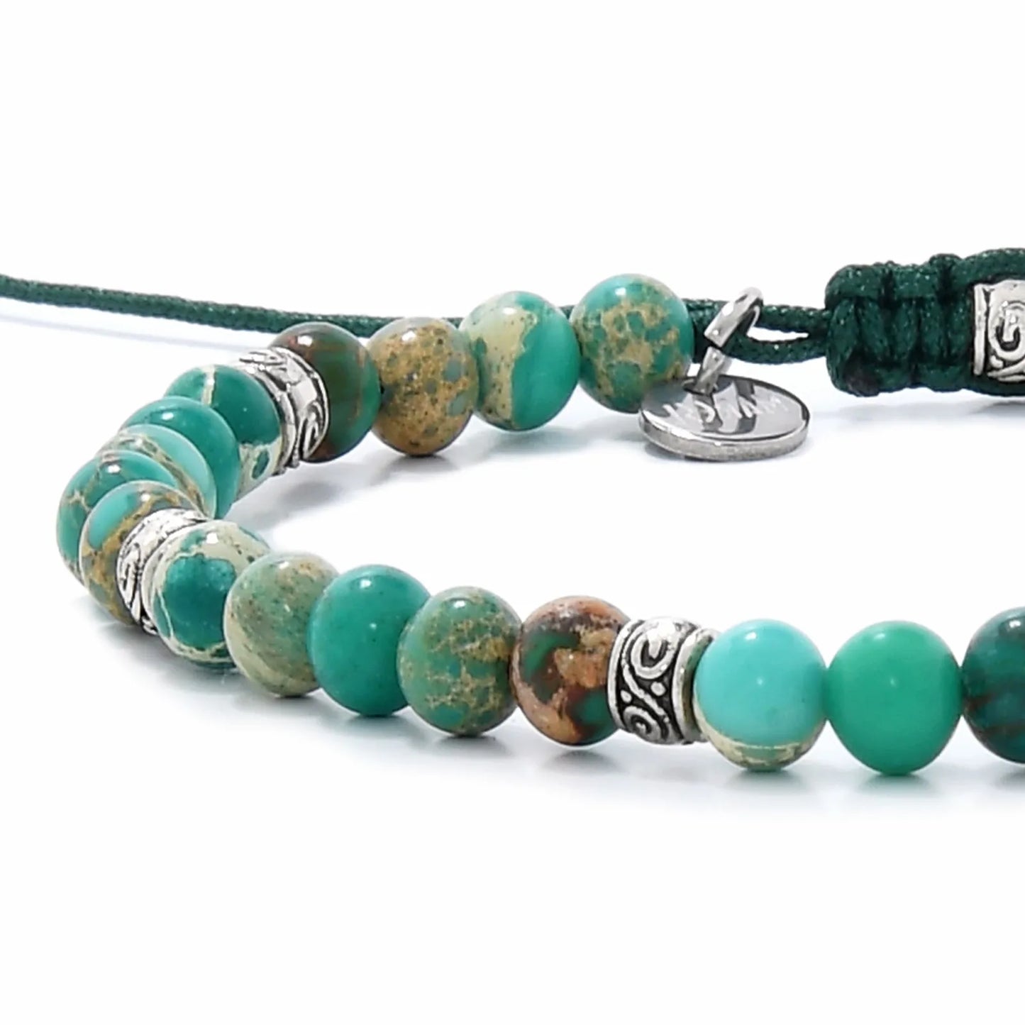 Close-up of Green Jasper Braceletbeads showing turquoise stones, silver spacers, charm, and green cord.
