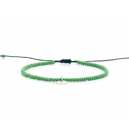 Minimalist green beaded stretch bracelet shown from side view