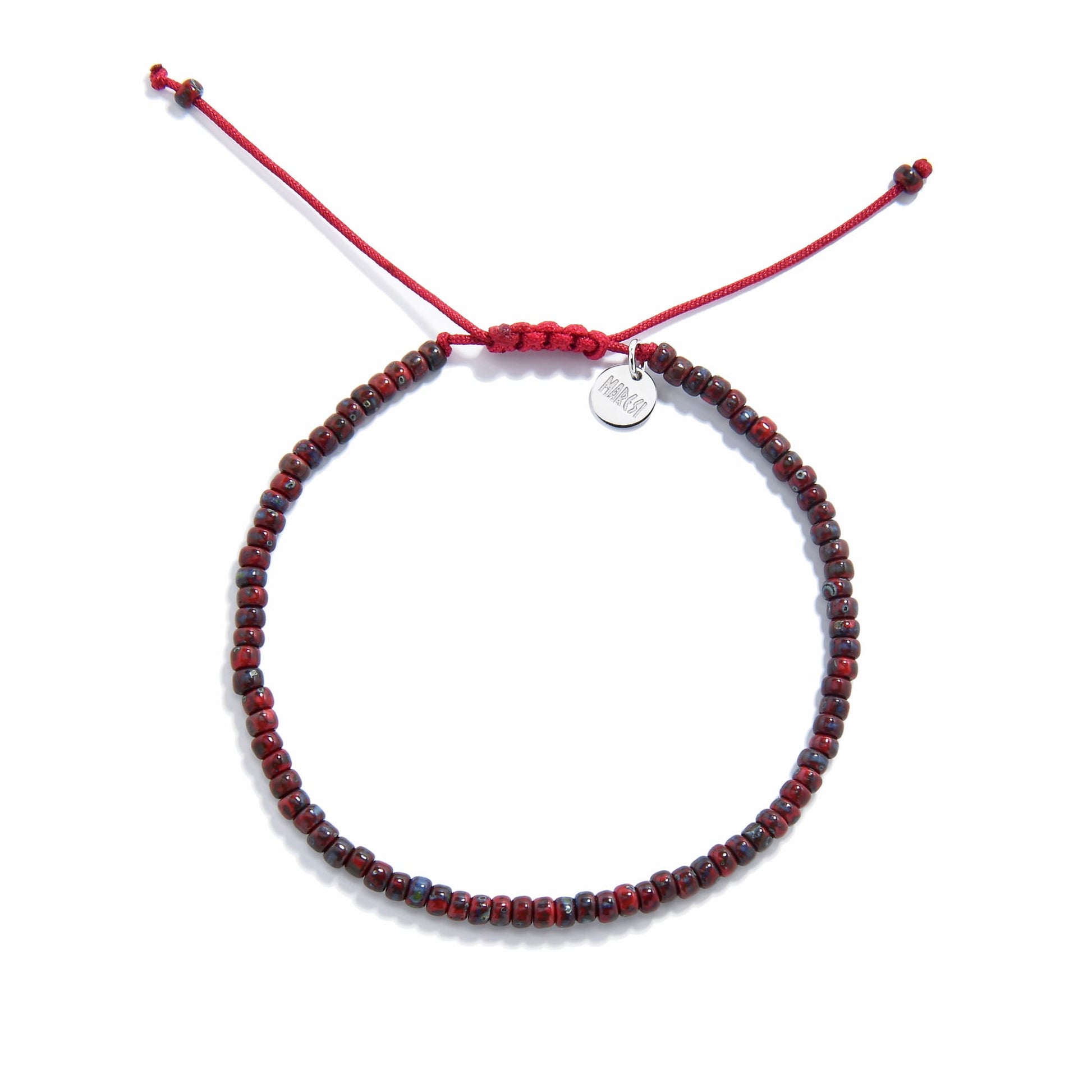Flat lay of handmade beads bracelet with deep red seed beads and red sliding knot