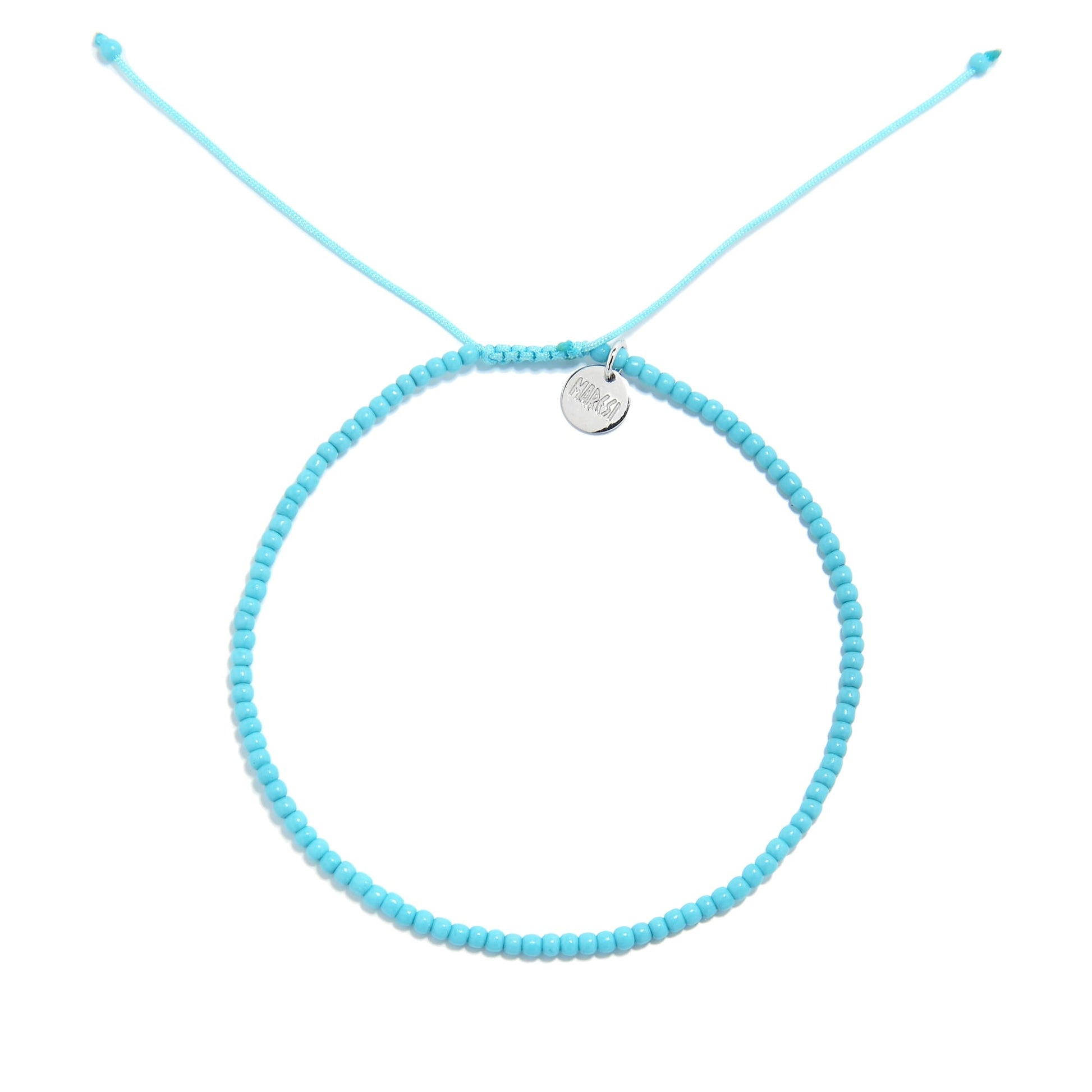 A top-down view of a light blue bracelet, an example of our mens beaded bracelets, arranged in a circle on a white background.