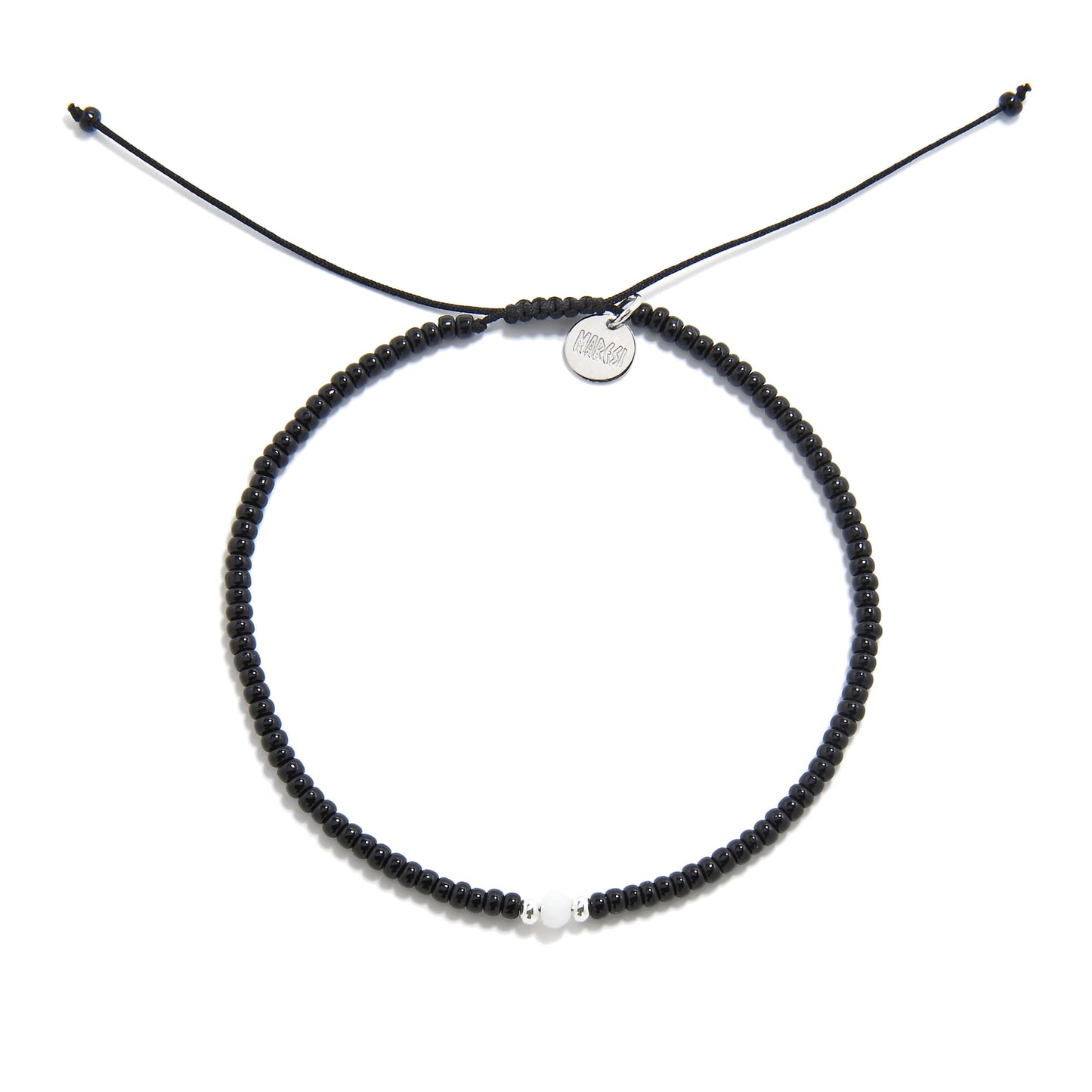Overhead view of Loreto Blanco Diamanti bead bracelet black in circular form with white accent bead