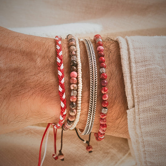 Detailed view of stack bracelet from Marseille set in silver and red, styled on male wrist