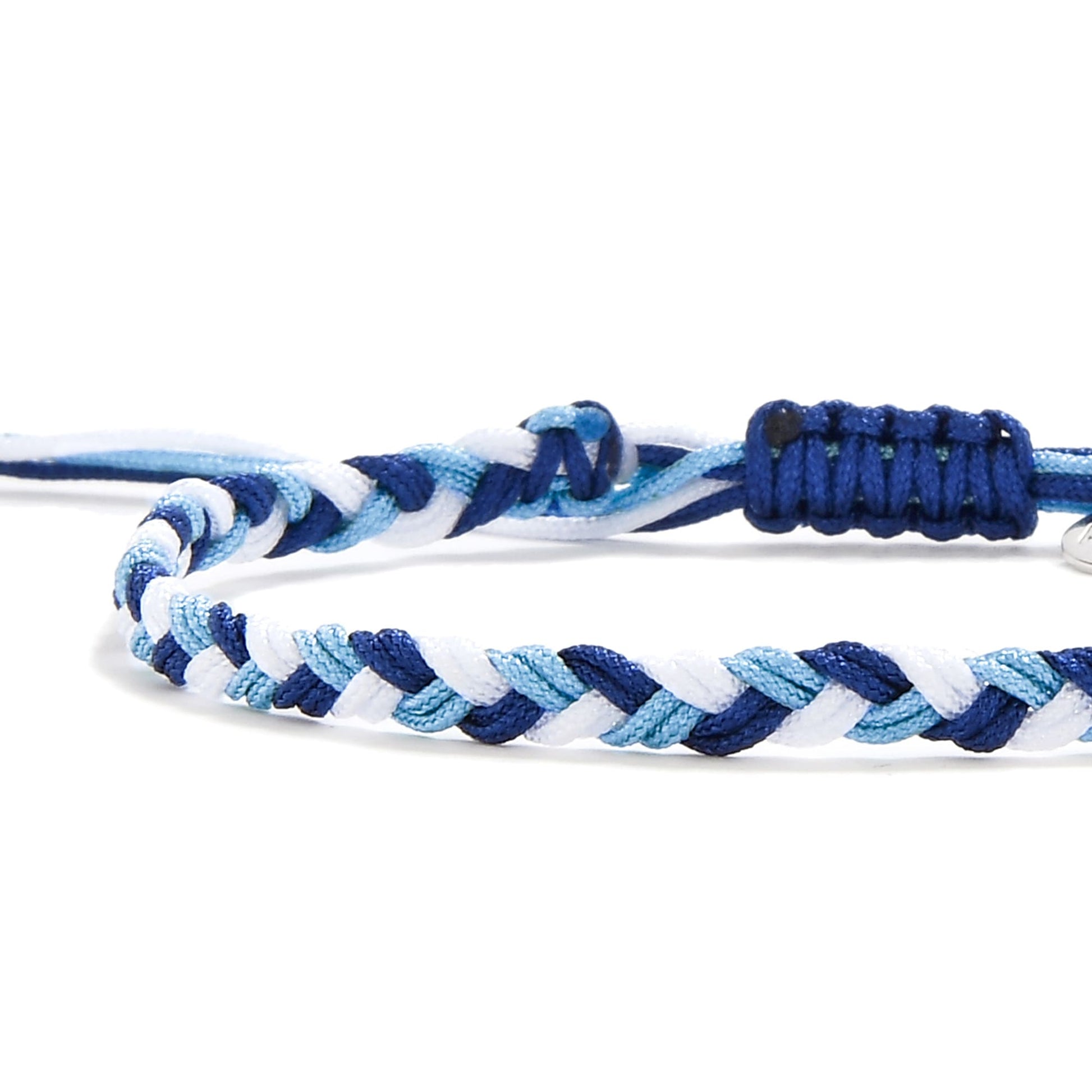 Close-up of matching friendship bracelets with white, navy, and sky blue braided cords