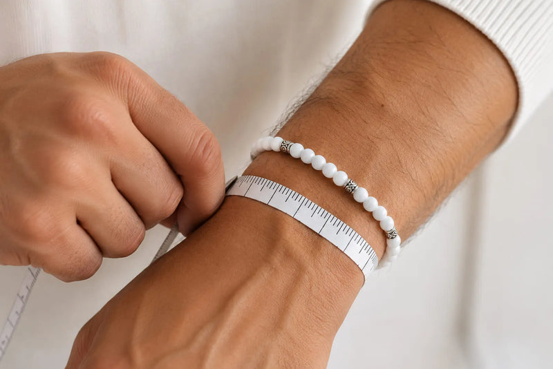 Jade Bracelet Beads sizing demonstration with a measuring tape wrapped around a man’s wrist