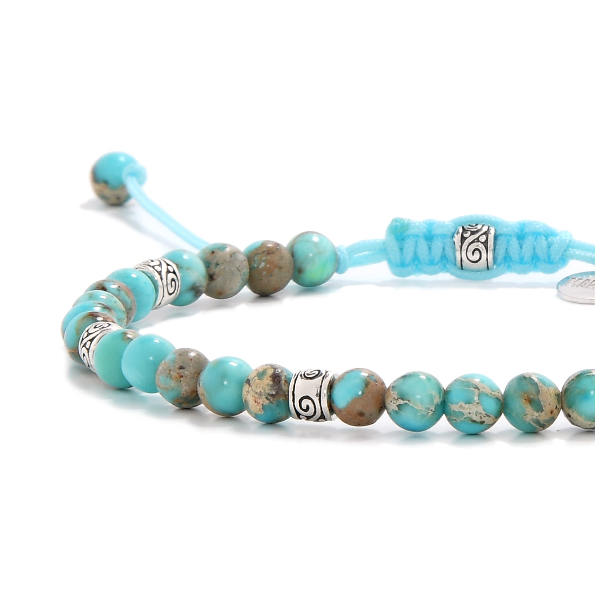 Mens turquoise bracelet close-up highlighting sea sediment stones and detailed silver spacers