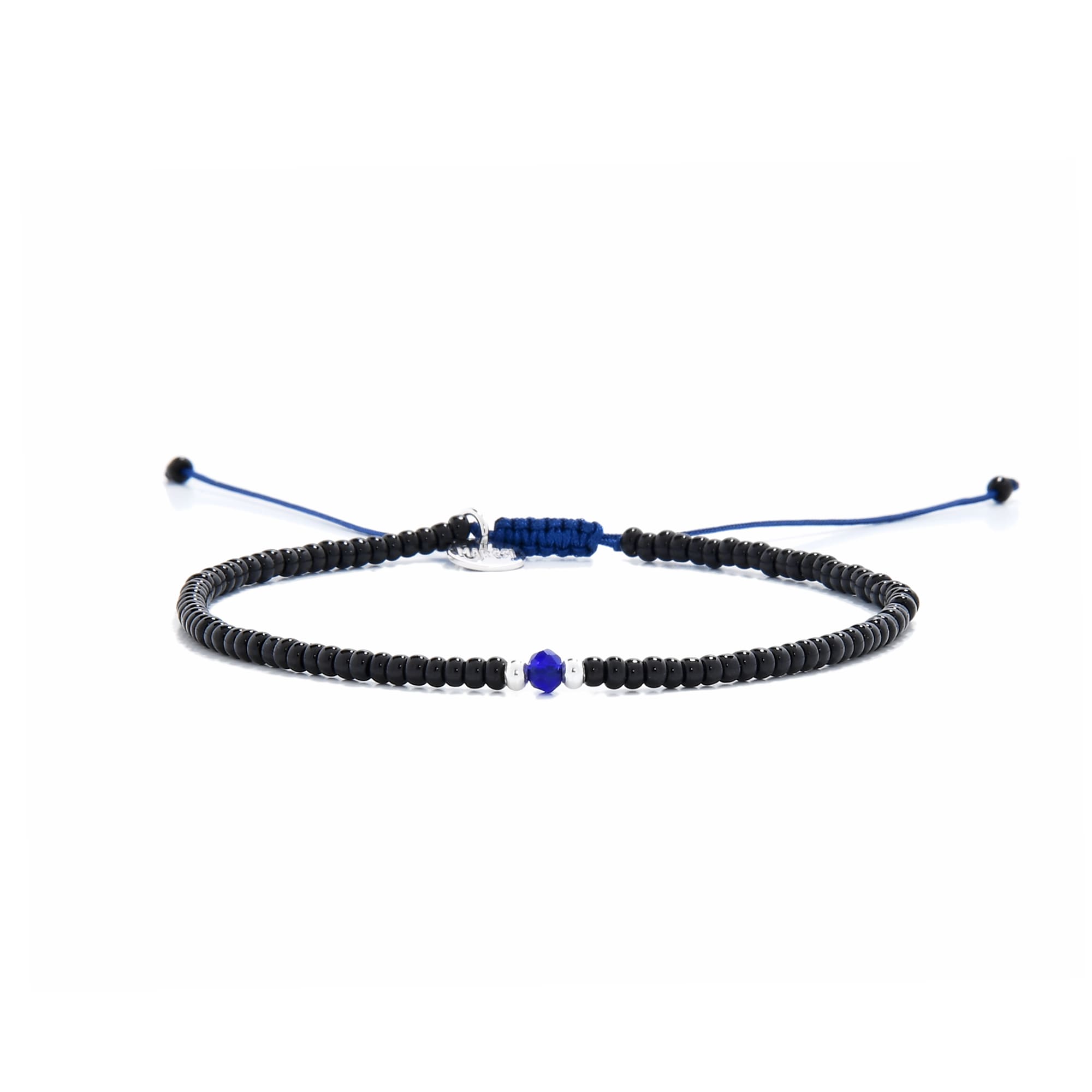 Minimalist bead bracelet with black beads, white spacers, and blue center on navy cord