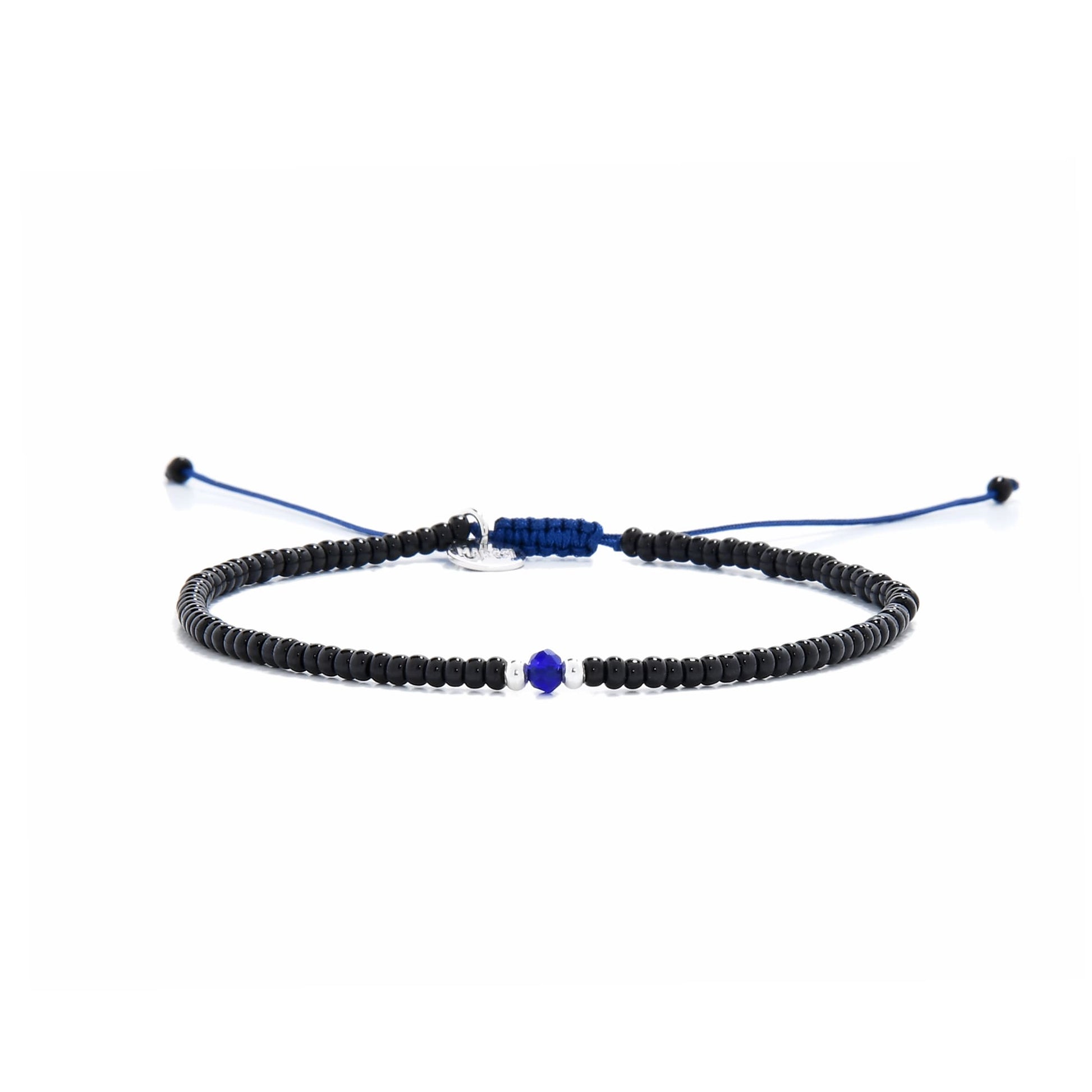 Minimalist bead bracelet with black beads, white spacers, and blue center on navy cord