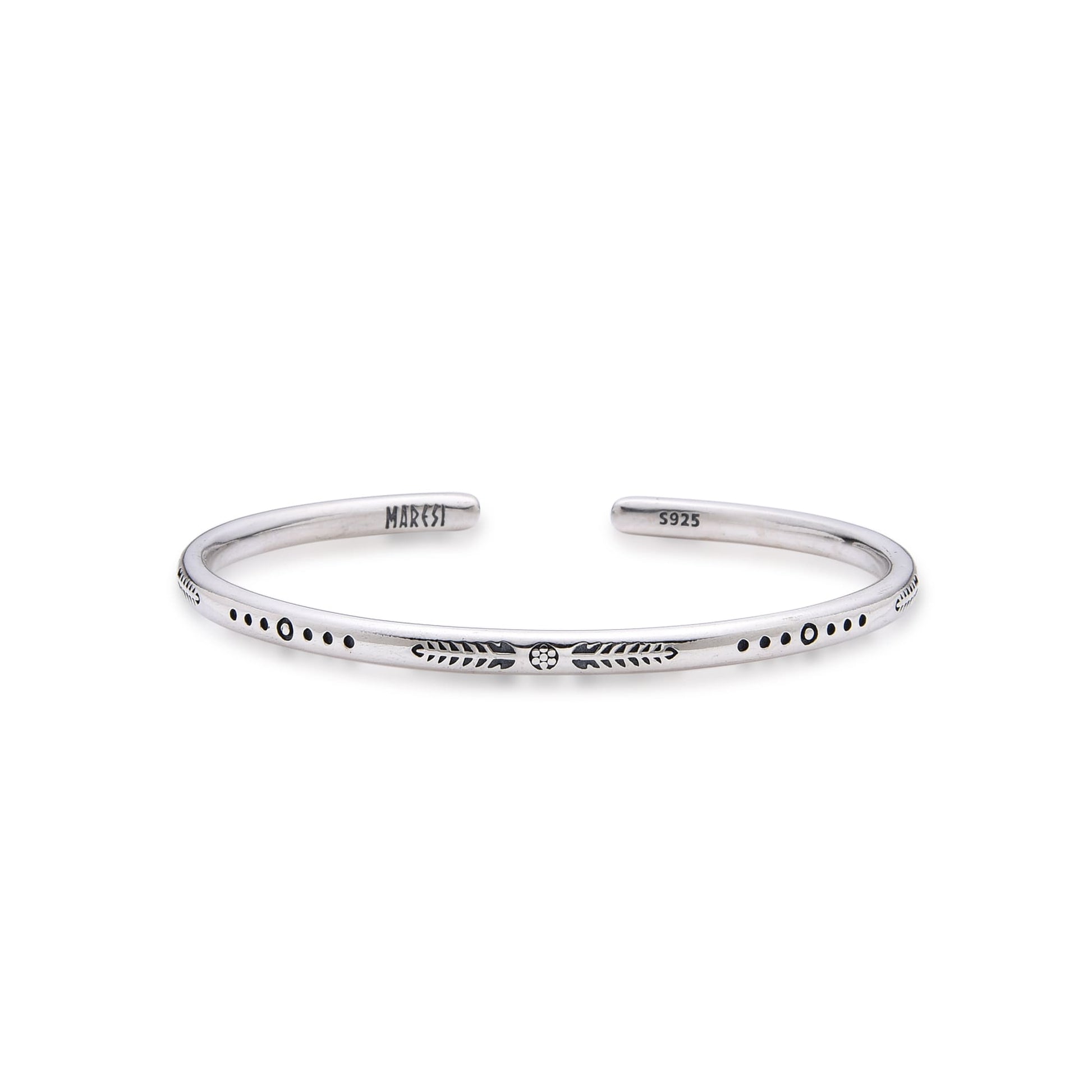 Slim silver bracelet bangle with engraved arrows and dots on plain background.