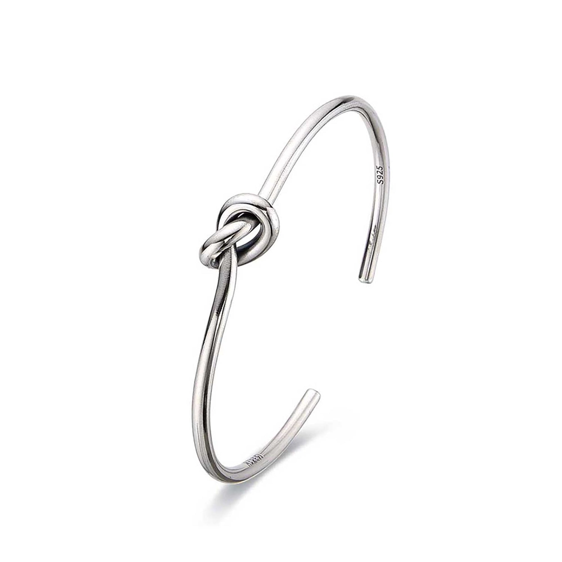 Polished mens cuff bracelets with knot centerpiece.