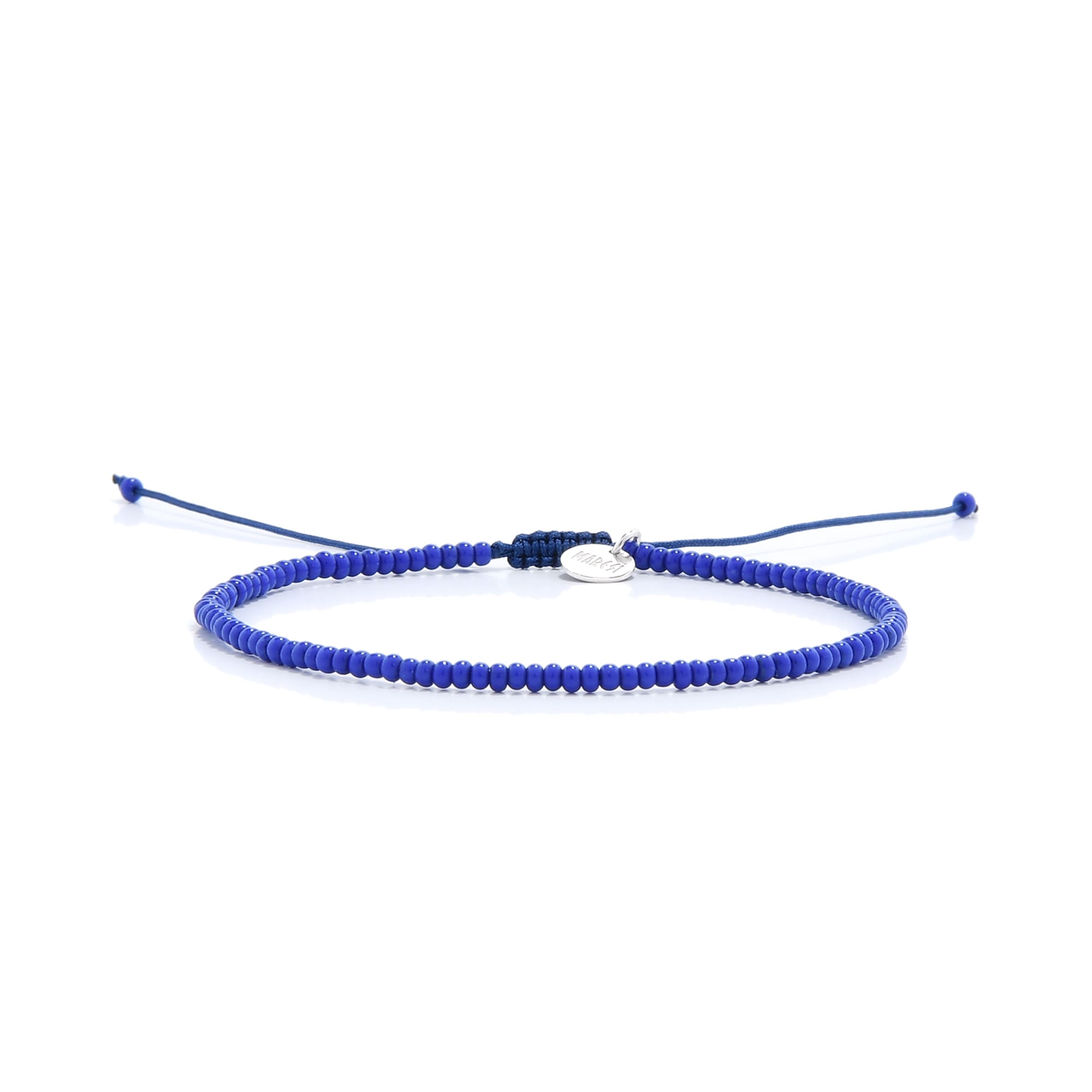 A single minimalist blue bracelet from our stretch bead bracelets collection laid horizontally on a clean white background.