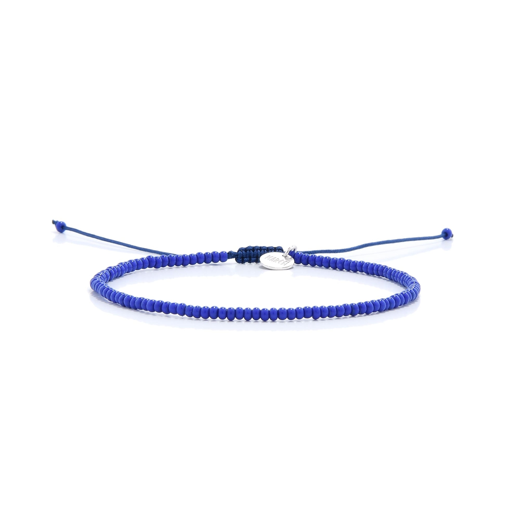 A single minimalist blue bracelet from our stretch bead bracelets collection laid horizontally on a clean white background.