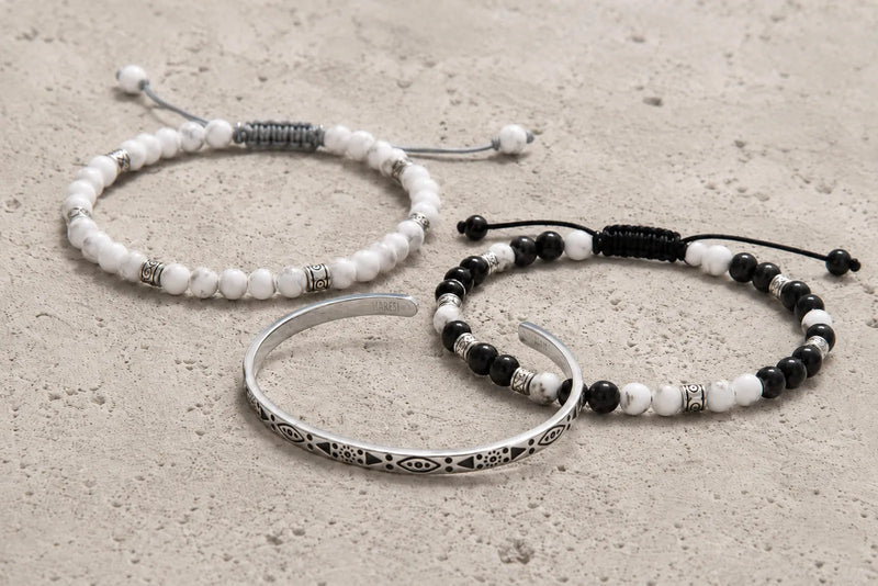 Navy, white and silver bracelet color combo arranged on sunlit Mediterranean limestone