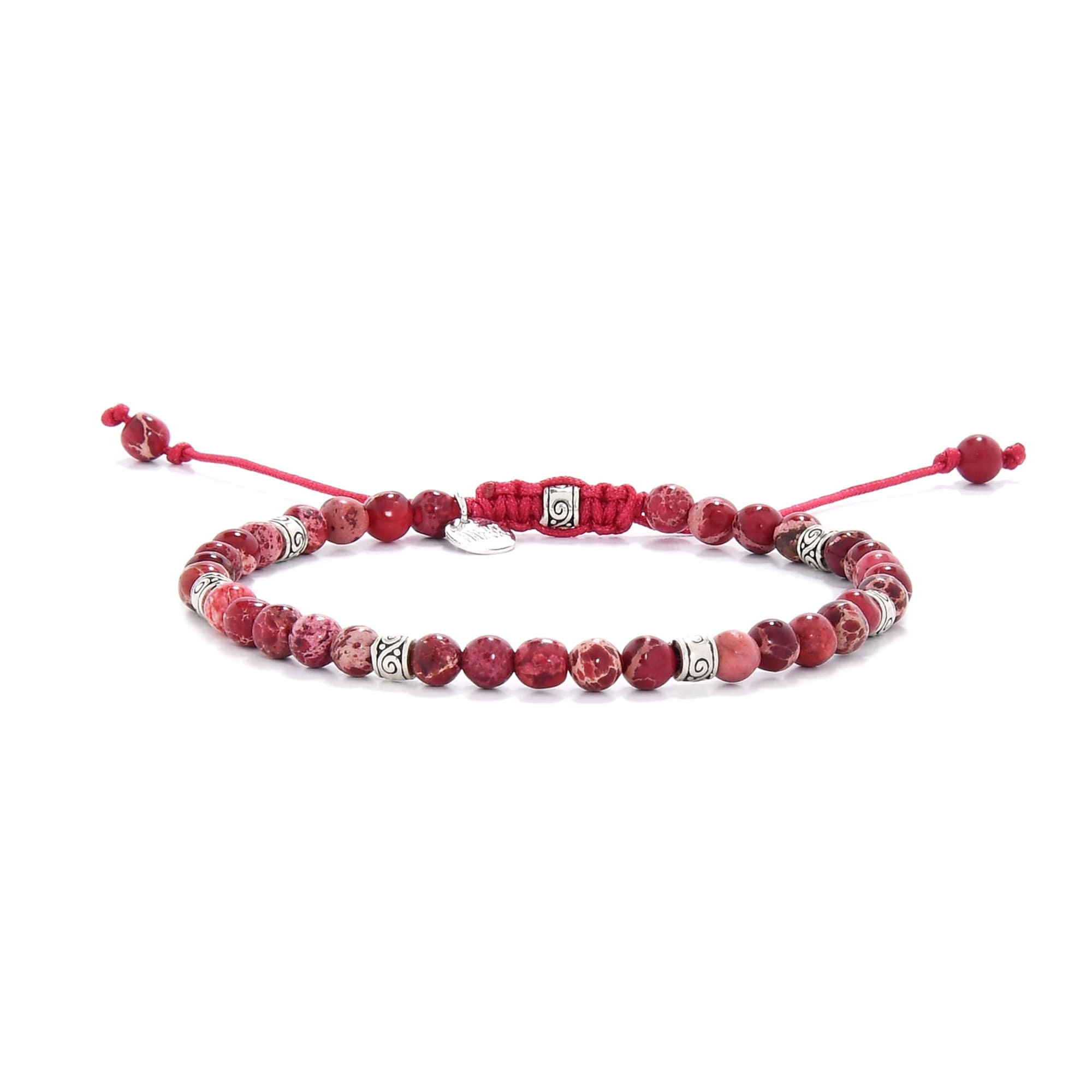 Handmade red jasper bracelet featuring round beads and silver spacers on red cord.