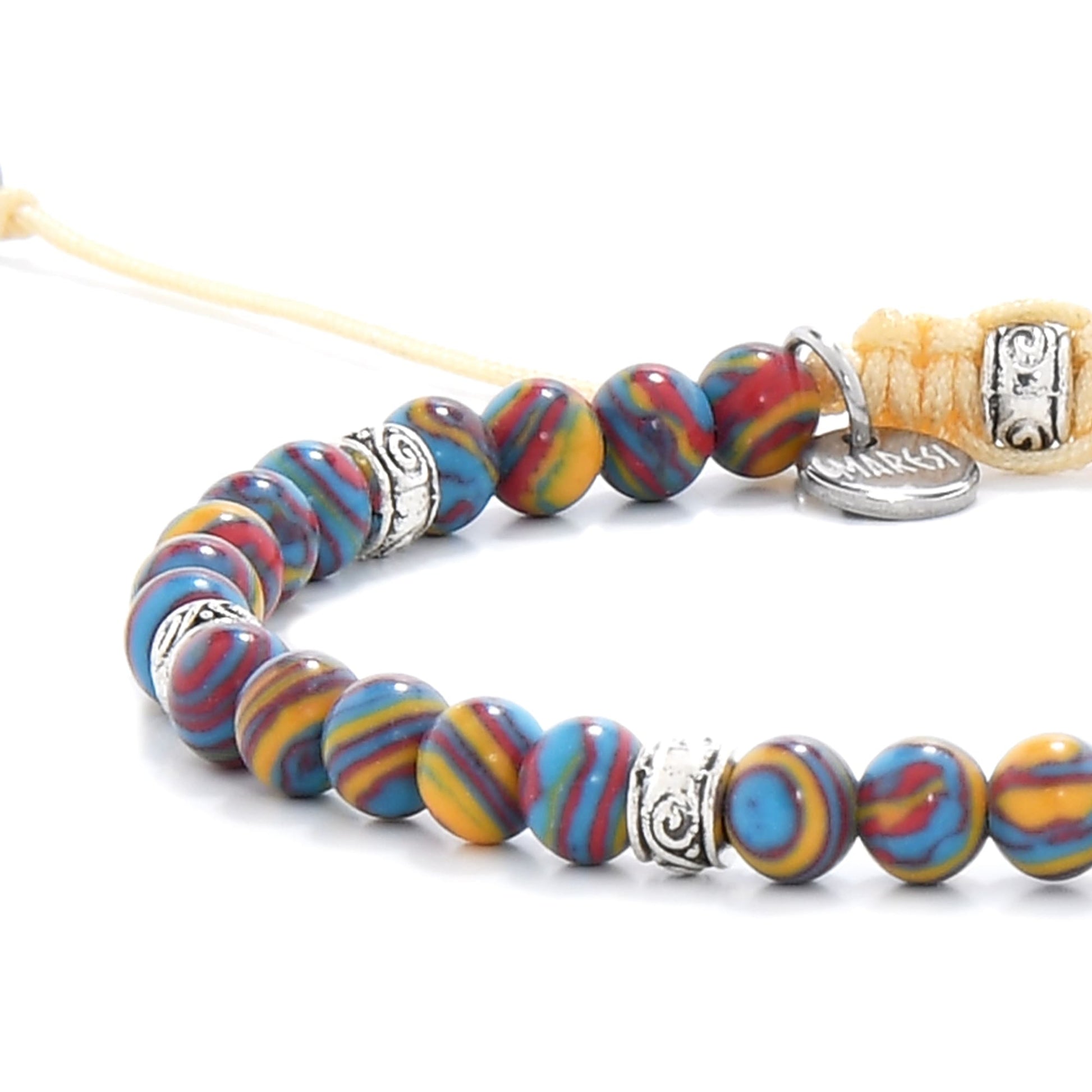 Malachite color bracelet detail view with polished round beads and metal charm near clasp