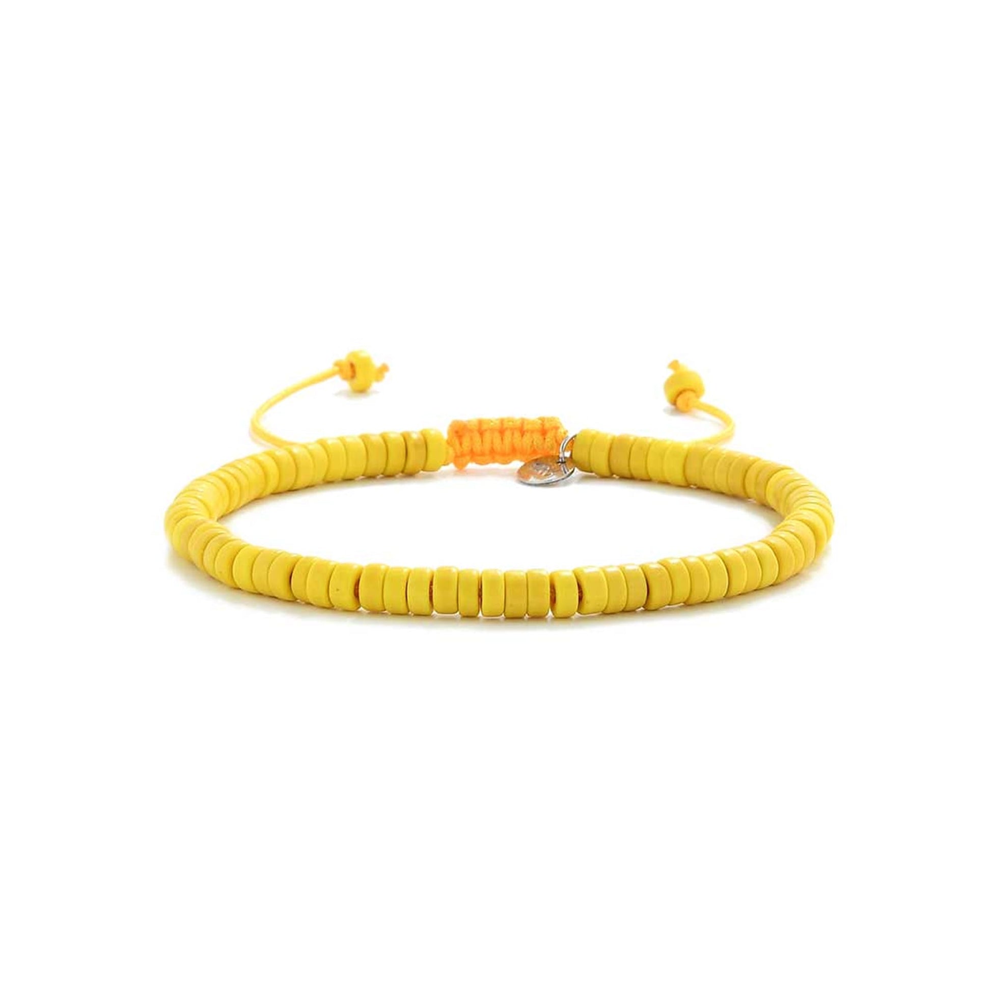 Handmade yellow bracelet with adjustable tie, laid flat on white background