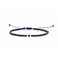 black and blue bead bracelet shown in full view with black seed beads with blue accent beads and adjustable cord