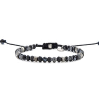 Full side view of the black and silver bracelet laid out flat with black cord and adjustable clasp.