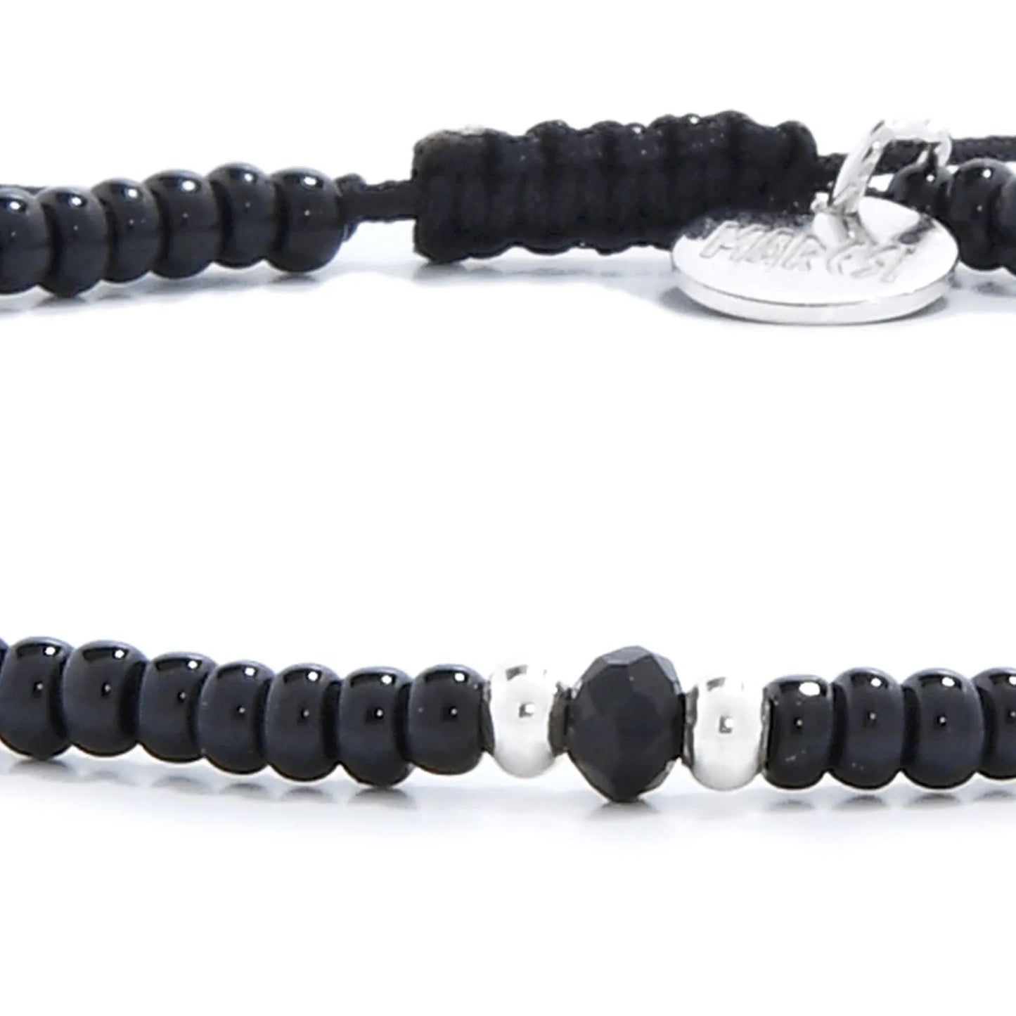 Detailed view of black crystal bracelet for men with black seed beads with dark faceted accents, seed bead texture, and cord knot