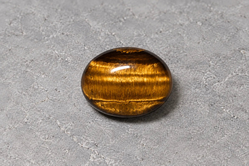 Colorful gemstones: golden-brown tiger's eye Oval tiger's eye cabochon with golden-brown bands and a silky reflected sheen