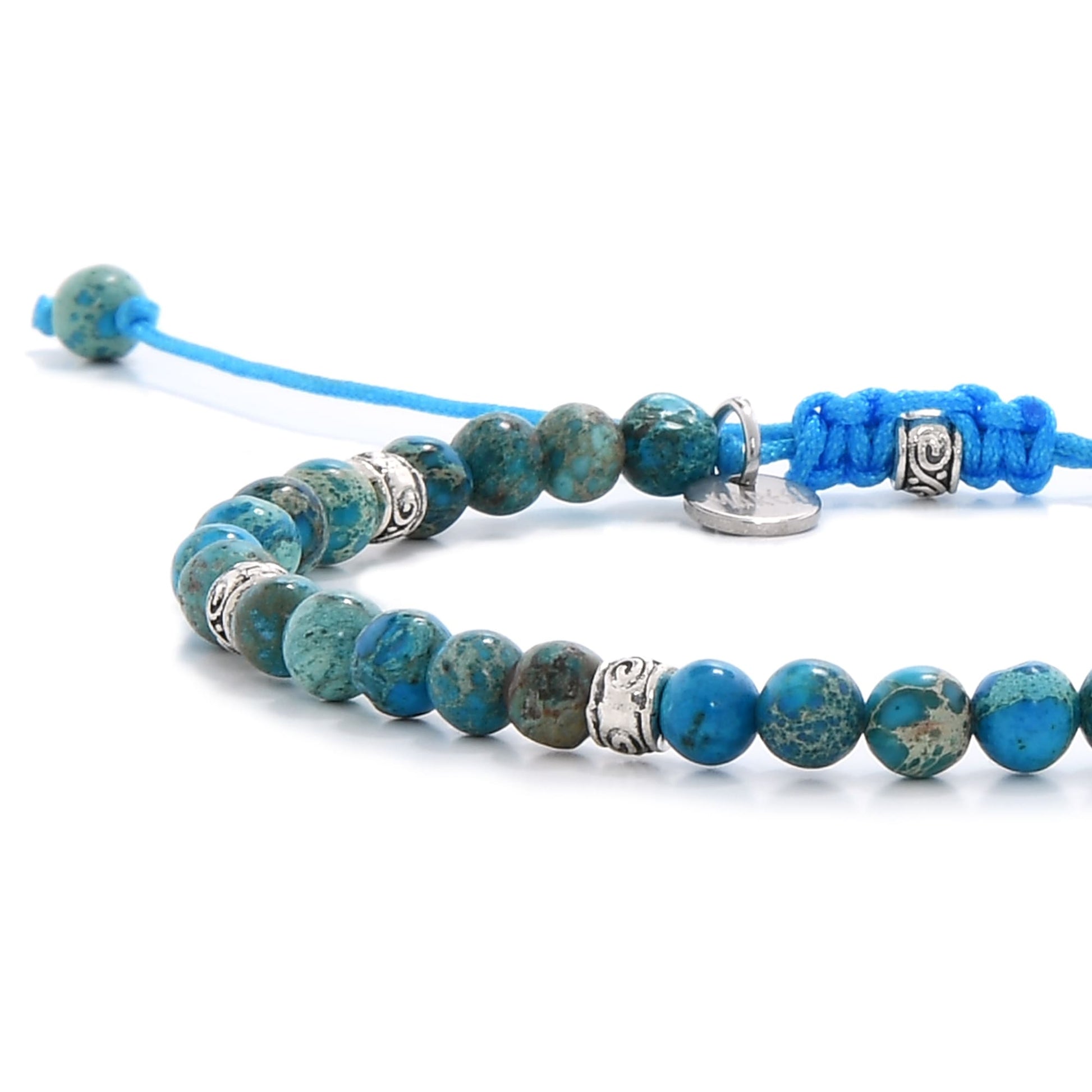ocean jasper blue close-up showing polished beads and detailed silver spacer charms