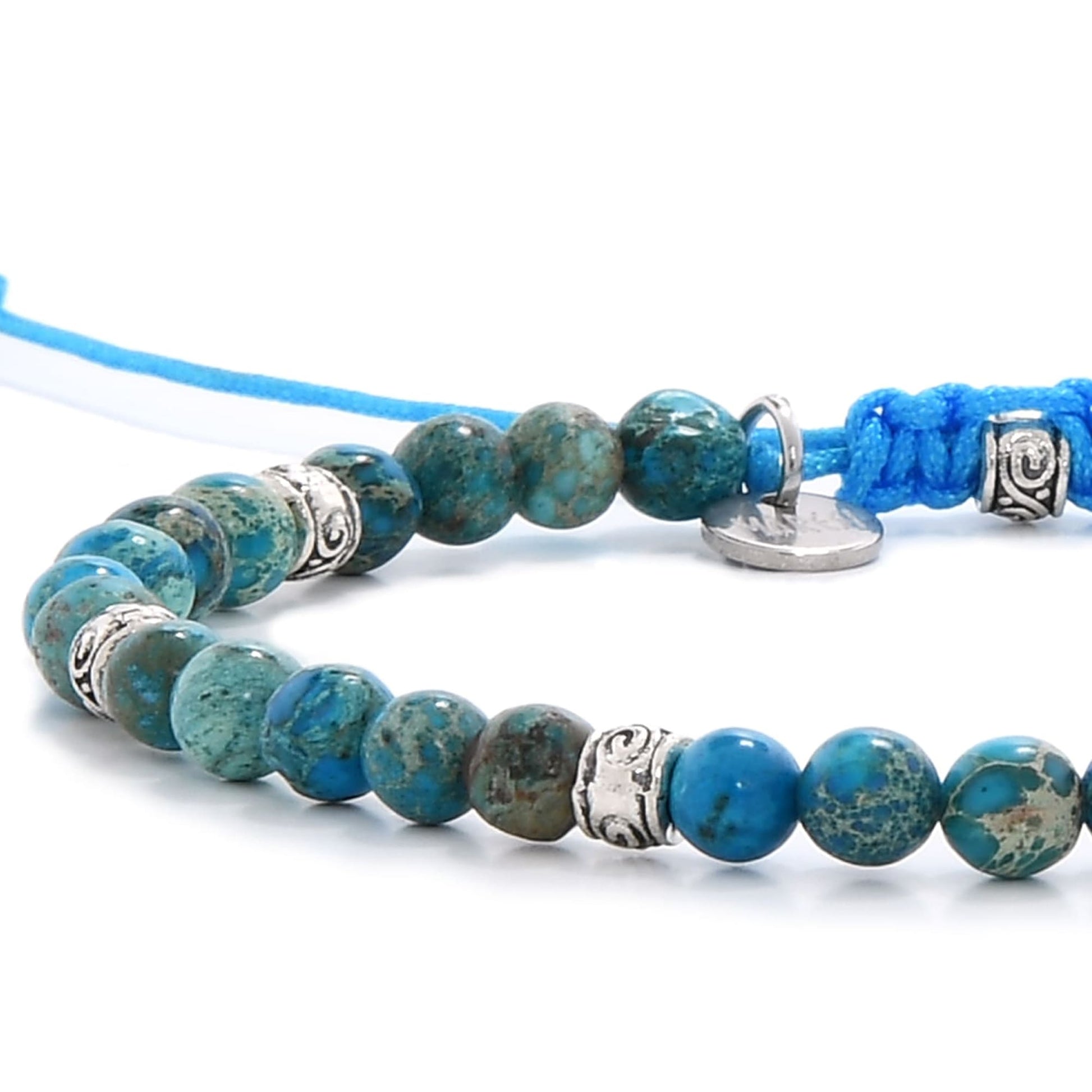ocean jasper blue macro showing polished beads and detailed silver spacer charms