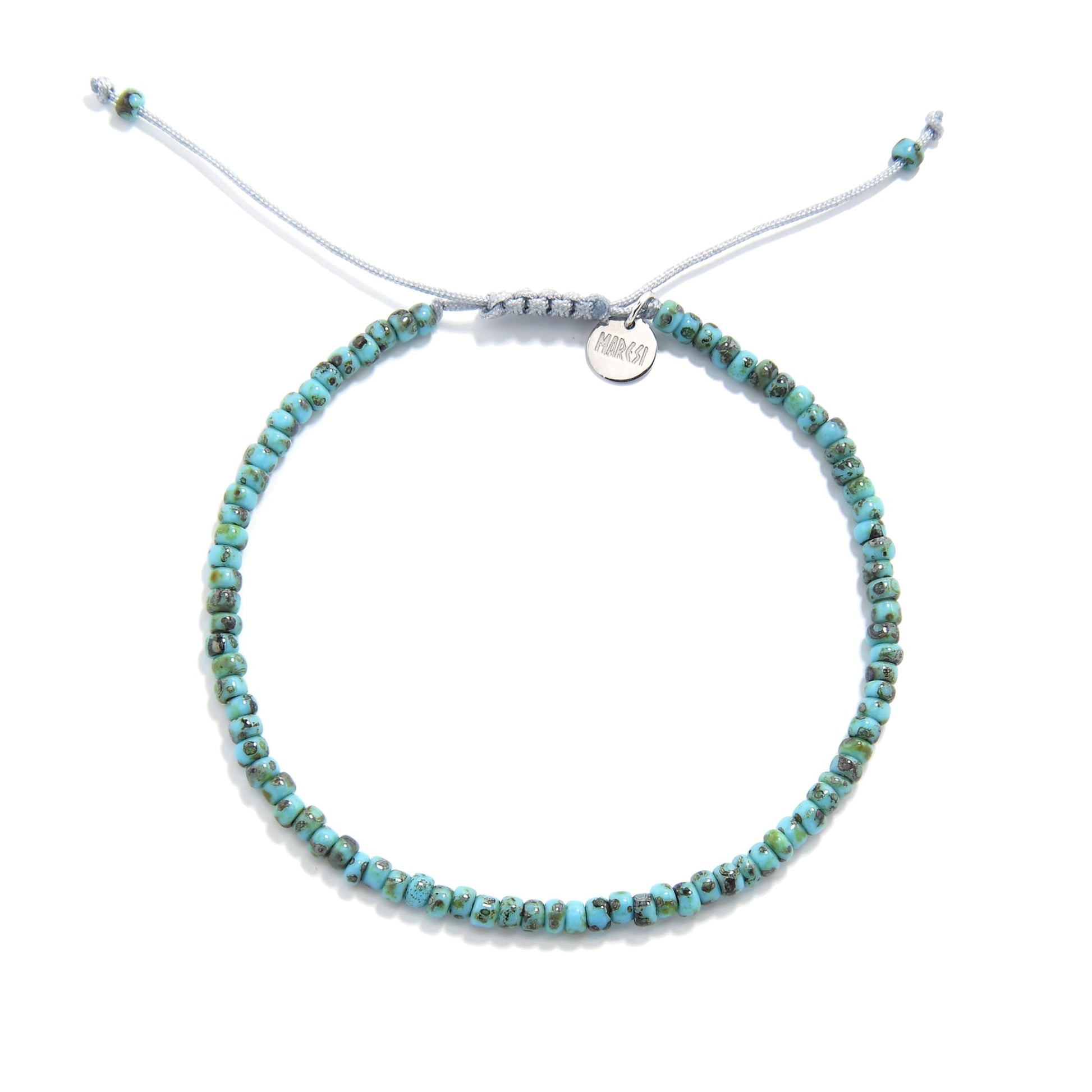 Full front view of beaded bracelet with turquoise picasso seed beads and sliding cord closure