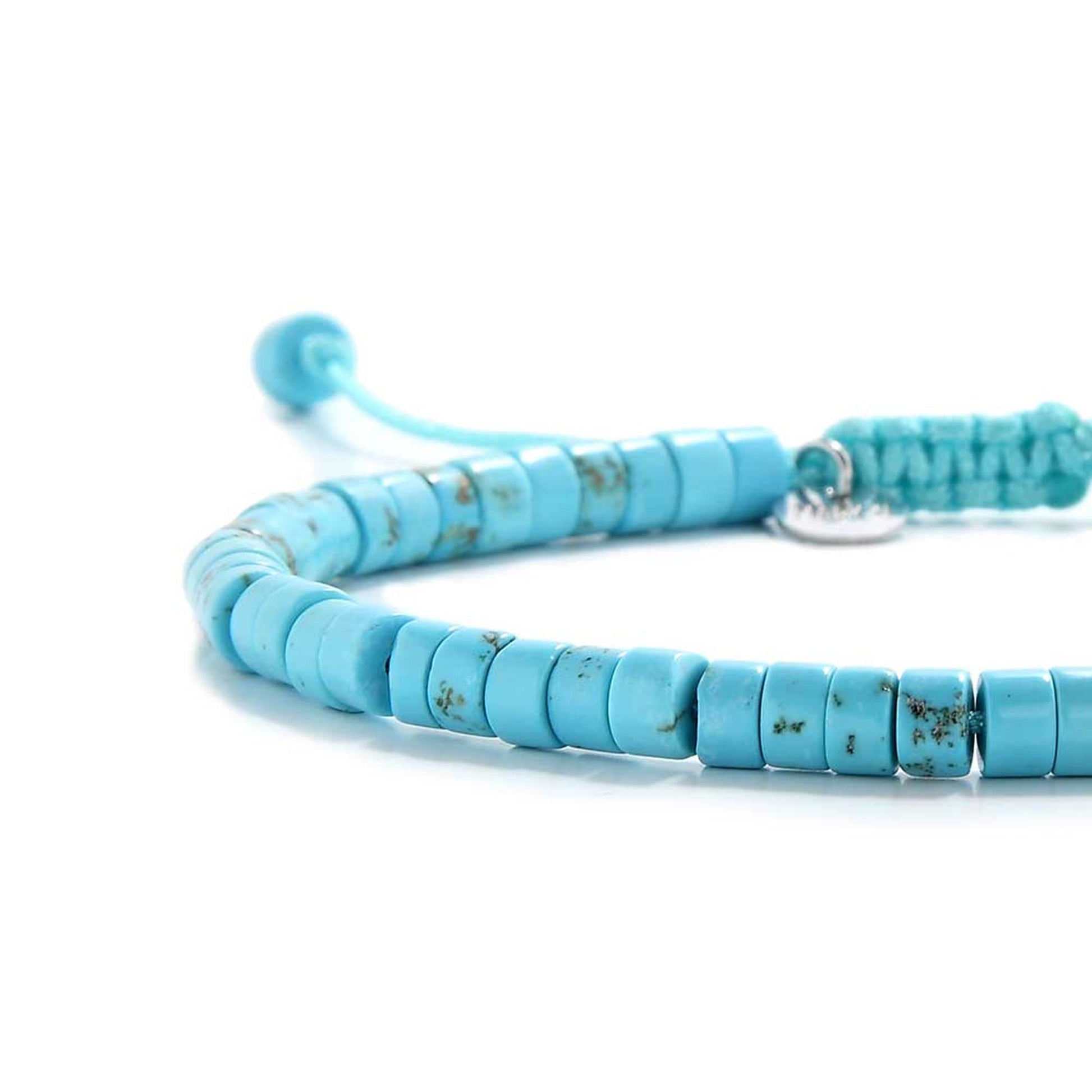Side profile of blue clay beads bracelet with silver spacer and macramé cord